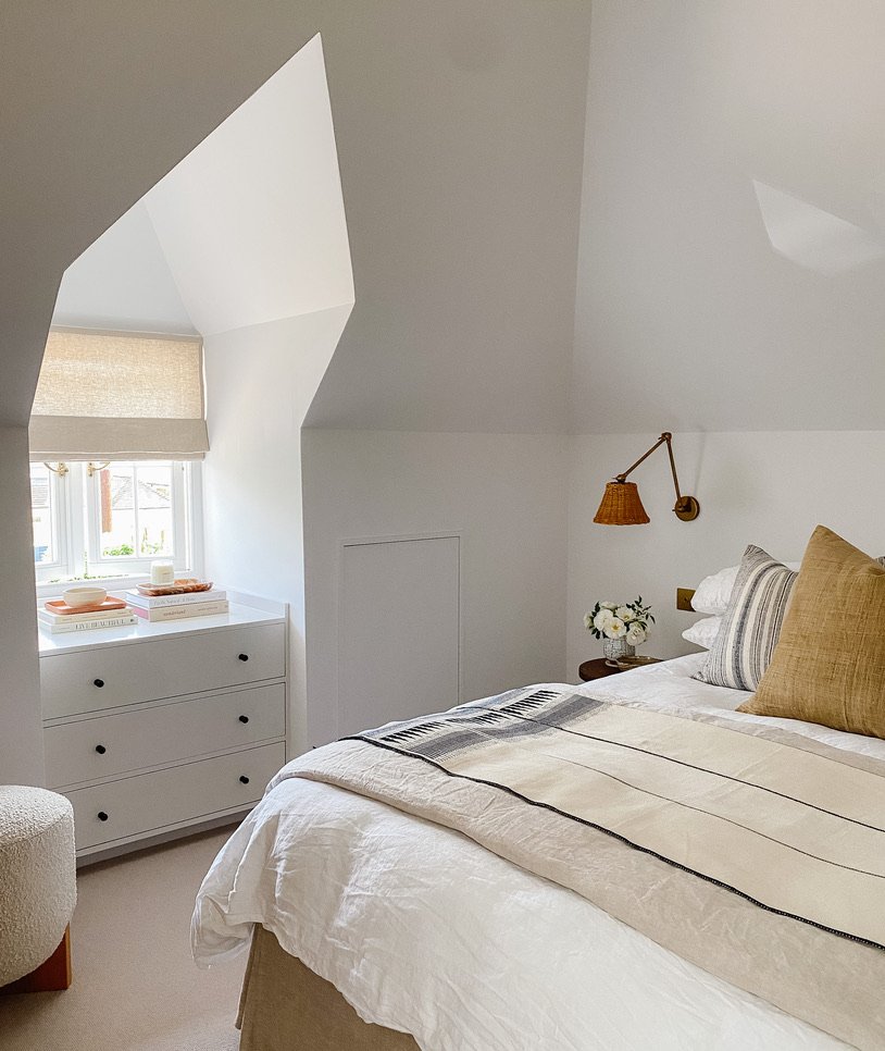 Bedroom with curated collection of artisan cushions