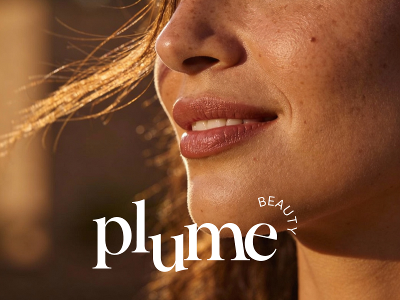 Plume Beauty visual identity featuring an elegant white serif wordmark and curved BEAUTY typography over a close-up portrait of a woman's face, illuminated by warm golden sunlight.
