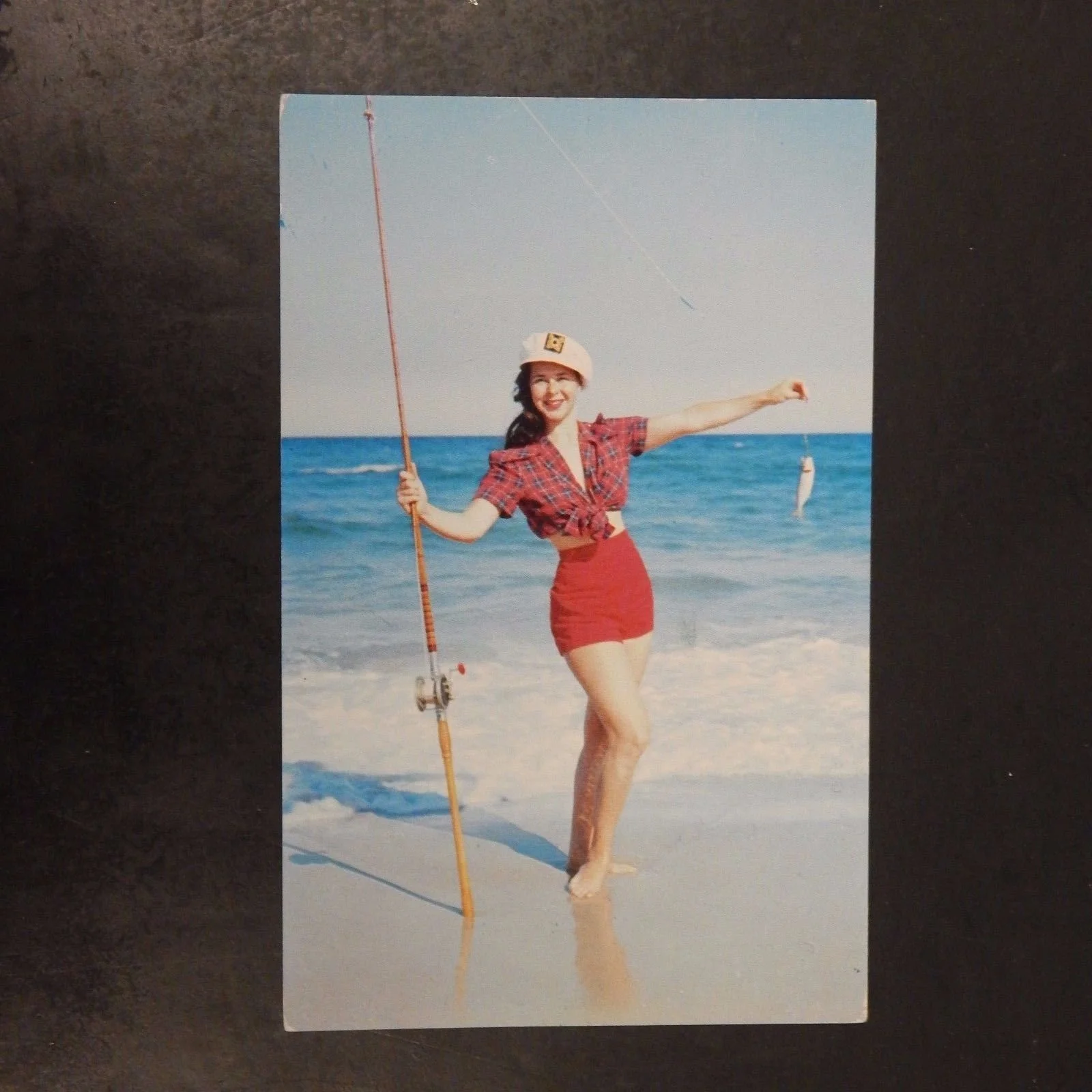 1957 Woman On Beach With Rod And Fish.jpg