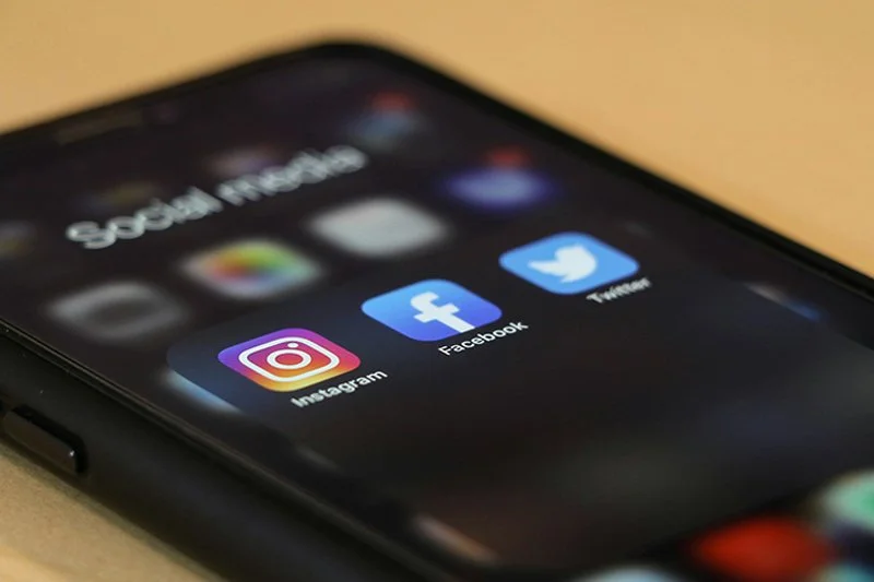 Social media apps on a phone screen.