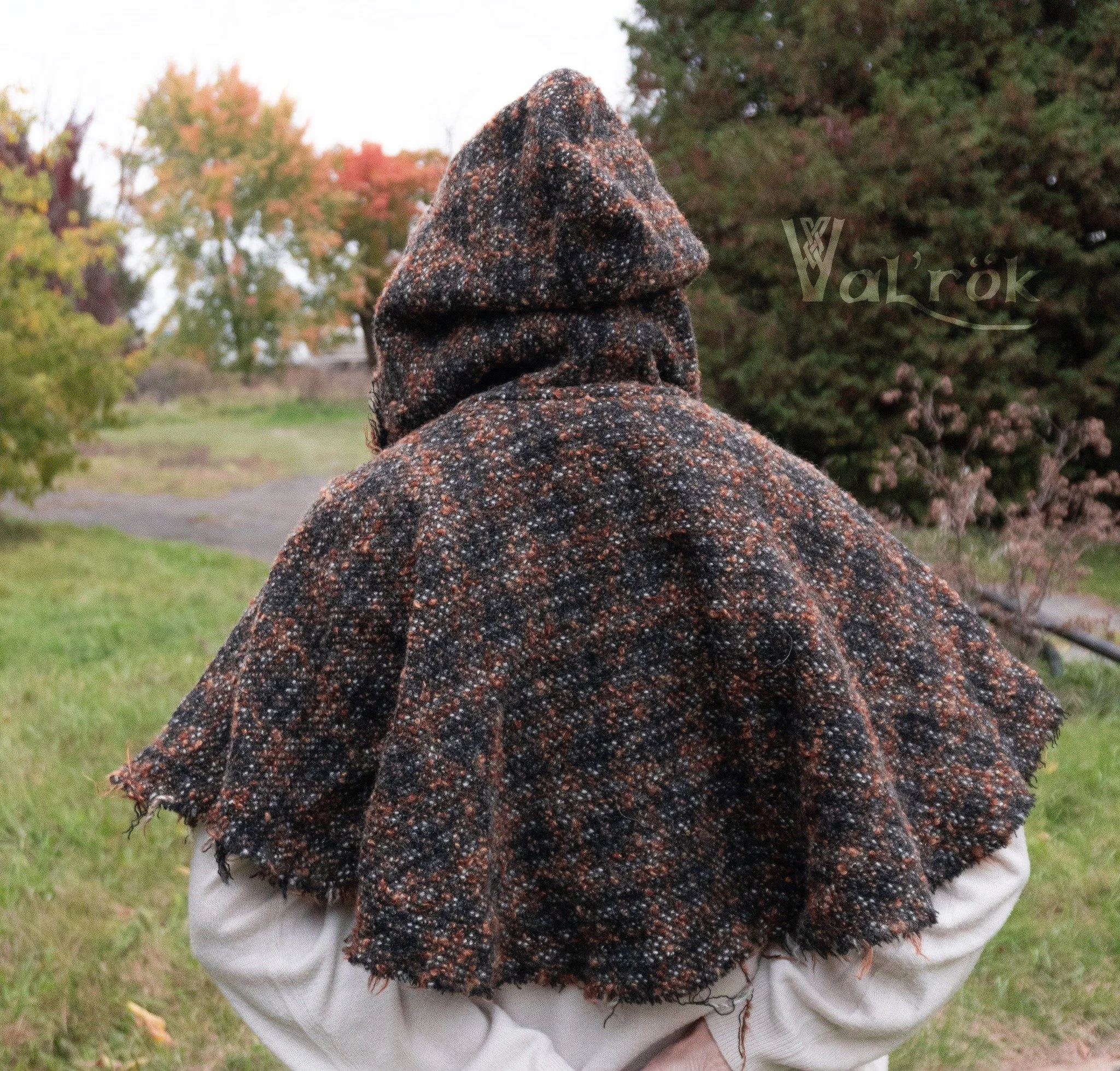 Black, brown, orange and white plaid wool in a thick itchy little hood.  Raw edge with pleated topstich finishing line to avoid endless fraying. 

https://valrok.net/valrok/p/cape-en-laine-violette-avec-garniture-argente-en-inventaireclericwool-cloak