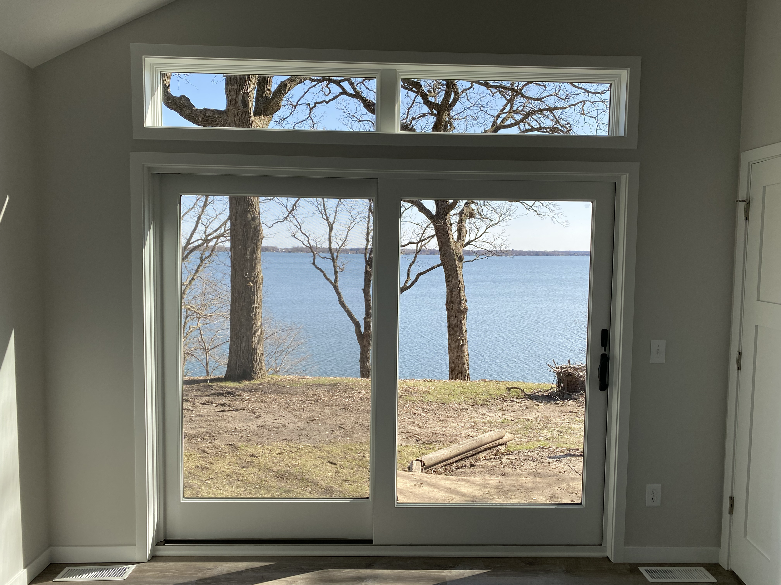Breathtaking view from the primary bedroom overlooking the lake.
