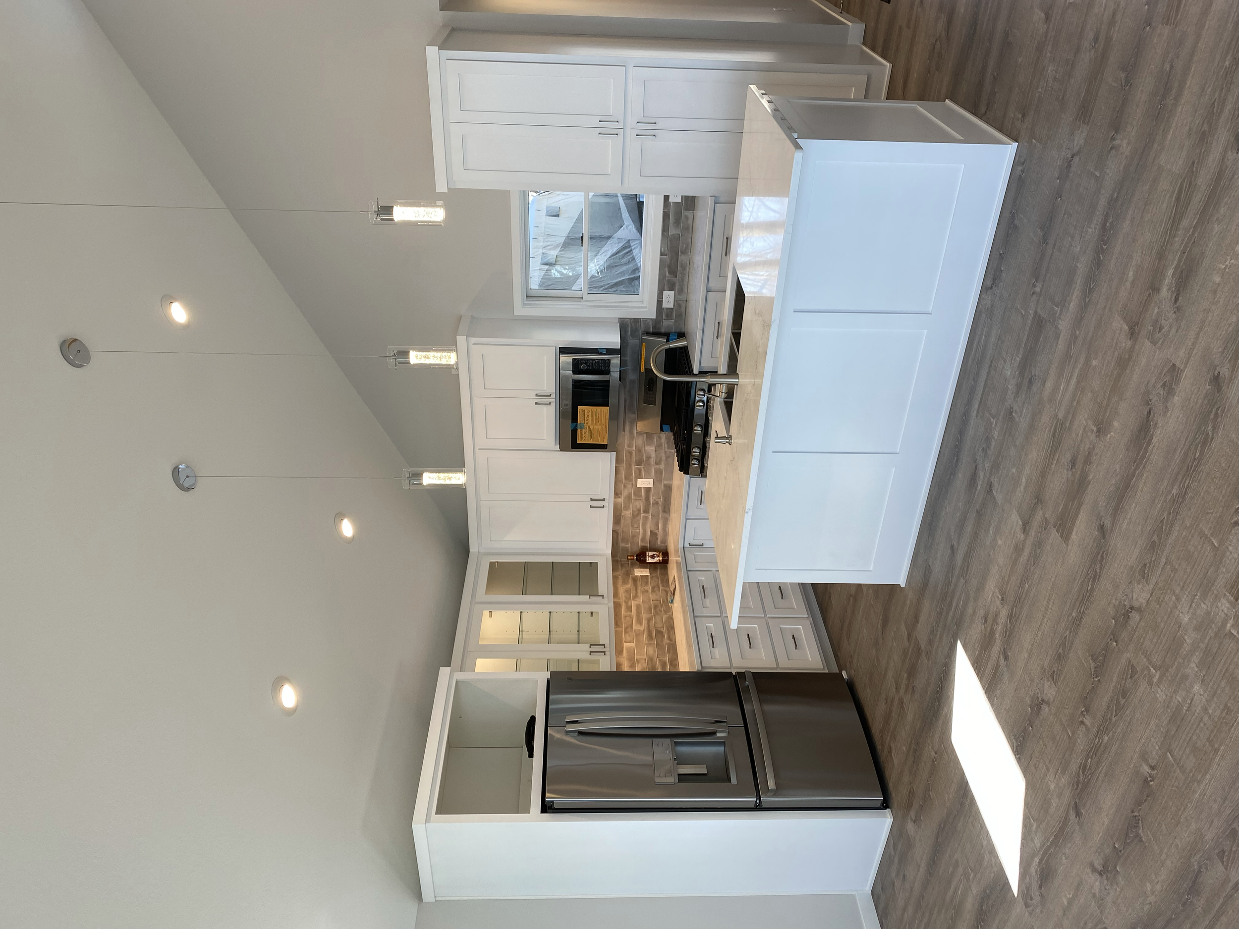 Brand new kitchen with a function layout with an island and new everything (appliances, custom cabinets, and stone countertops.