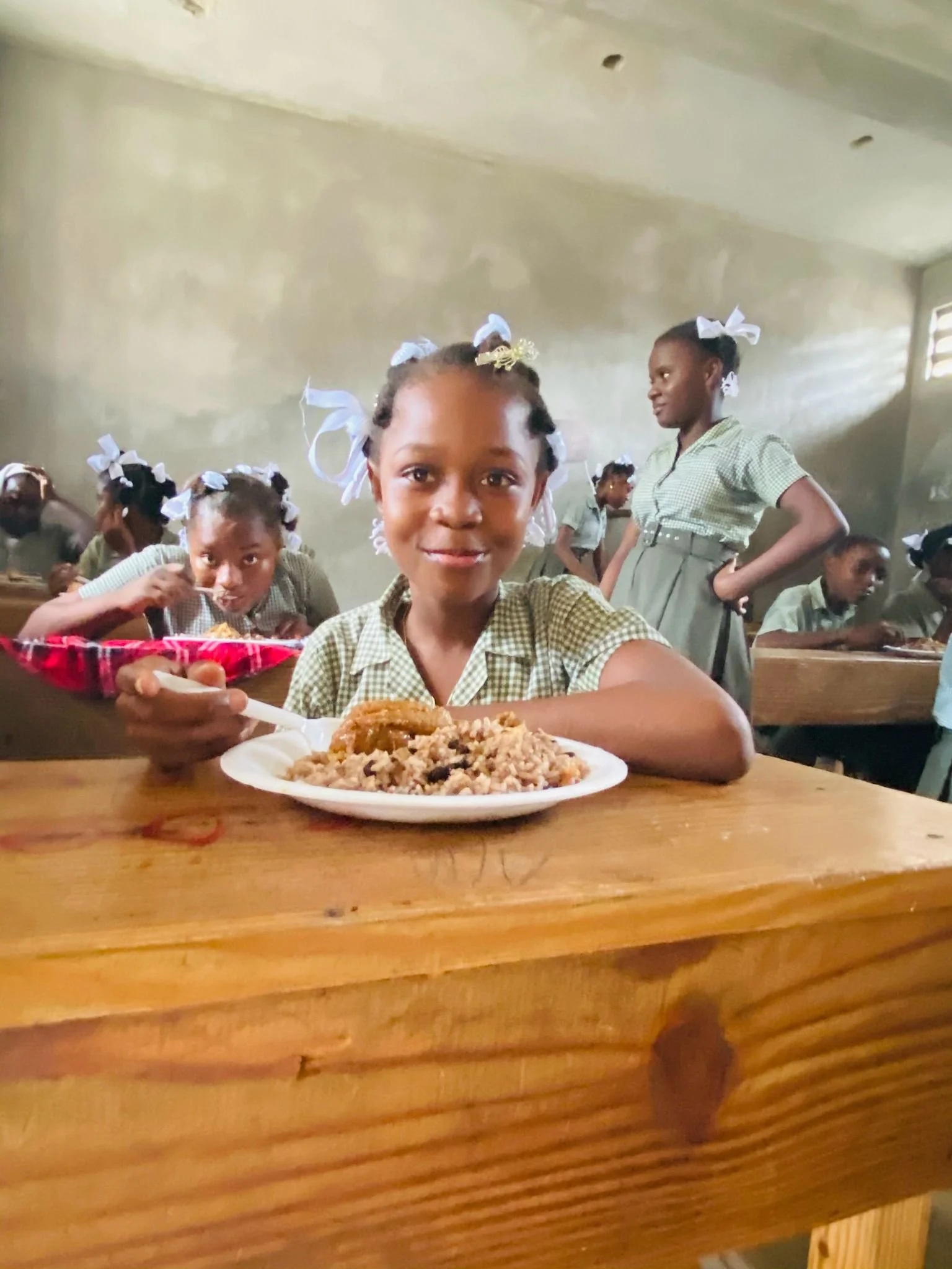 student in haiti having a meal