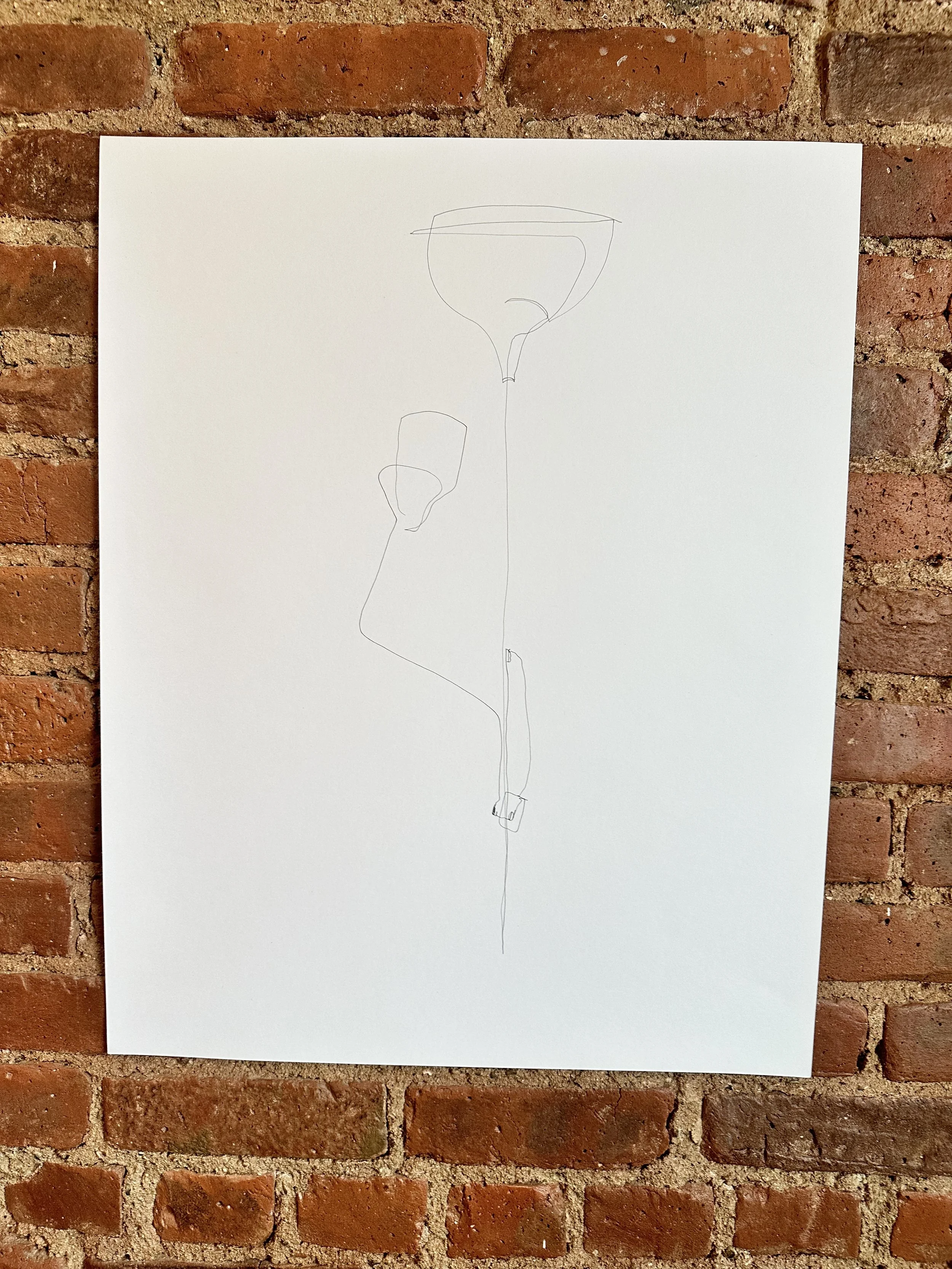 Minimalist line drawing of a street lamp with a brick wall background.