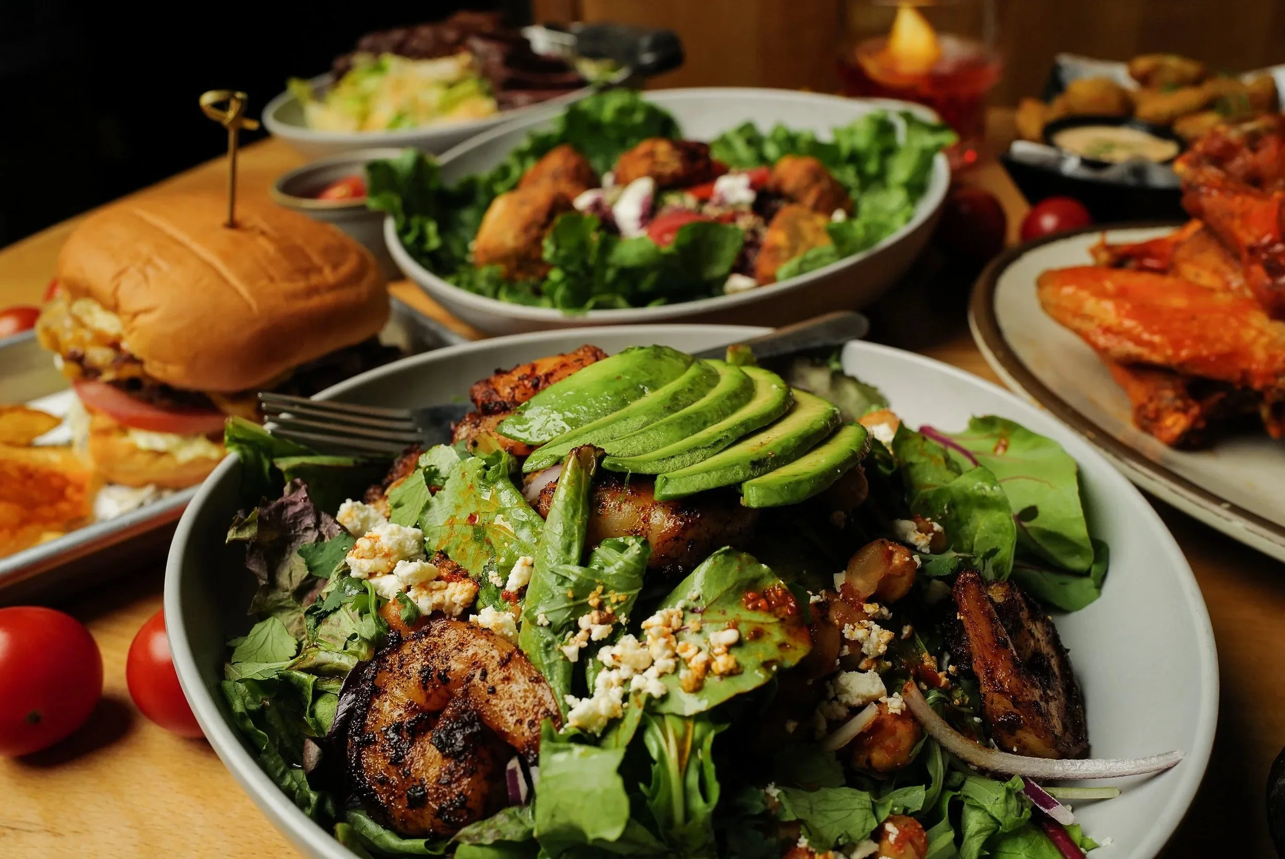 Chickpea Avocado Salad, Crispy Chicken Sandwich, Mojave Falafel Bowl, & Buffalo Wings (Photo credit: Kelly Gre)