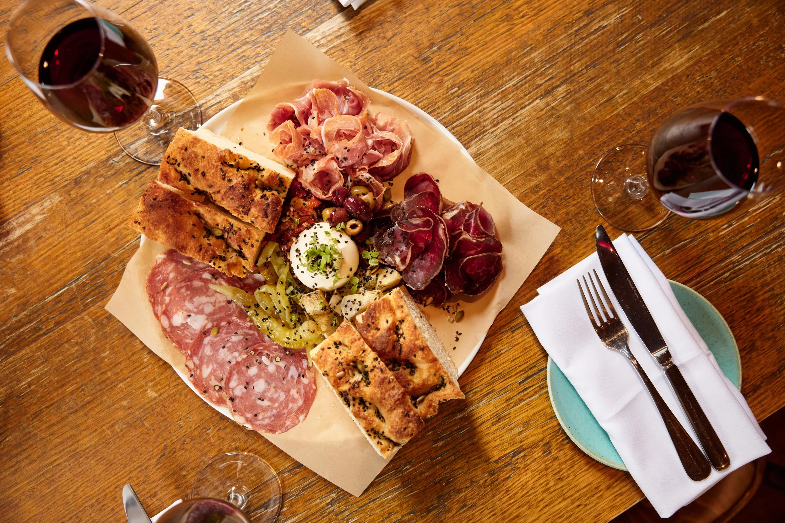 Cheese and meat platter with glasses of wine