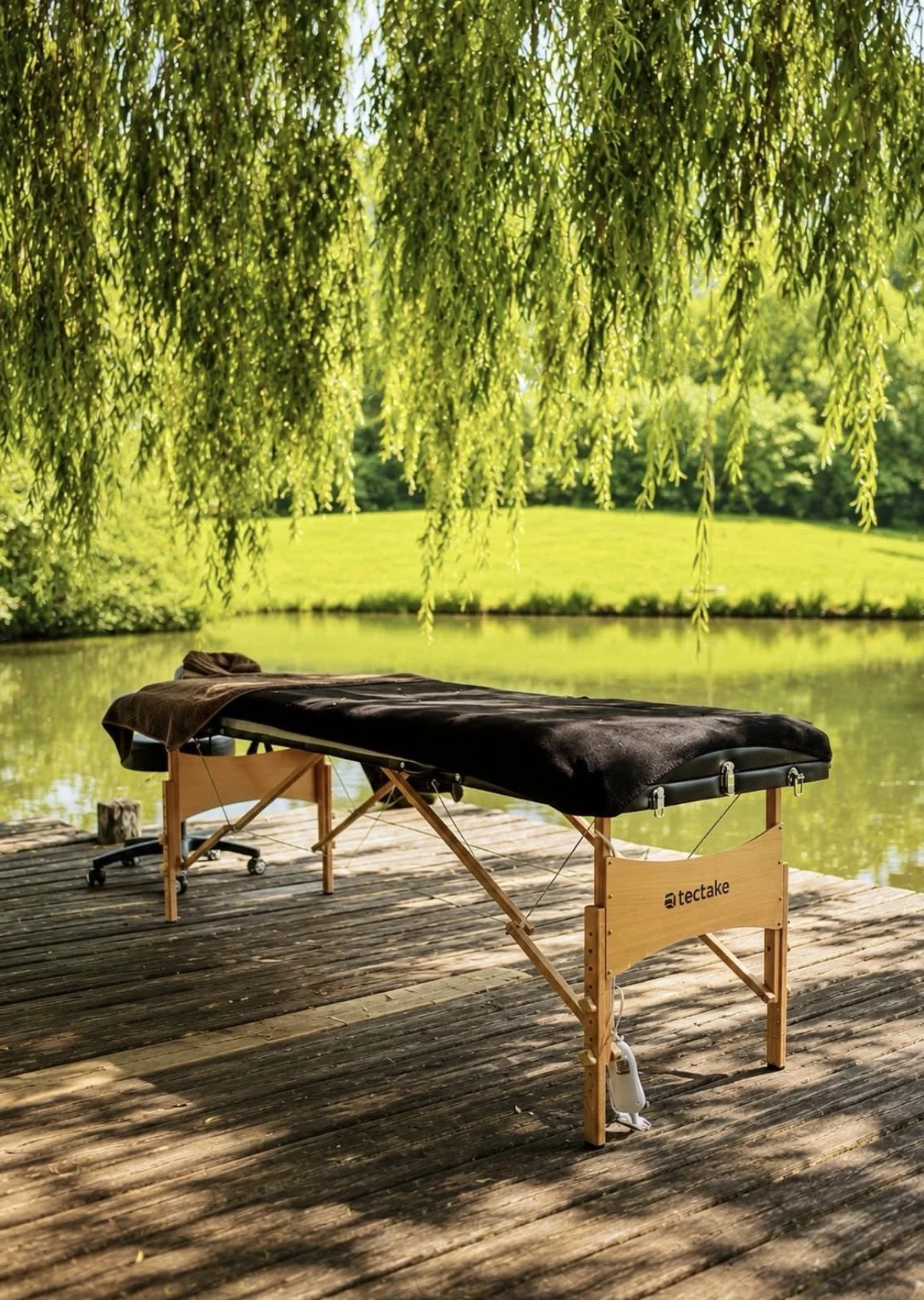 Wooden deck and island on the private lake at golden hour, Domaine de la Grausse, South of France