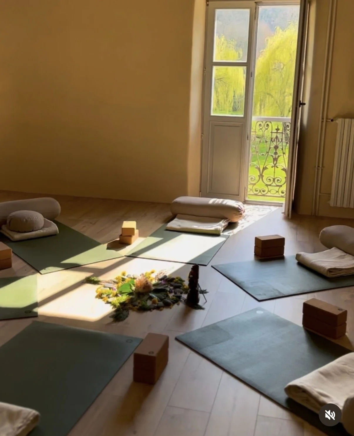 A light-filled yoga and sound healing shala with exposed beams at the women's retreat in France