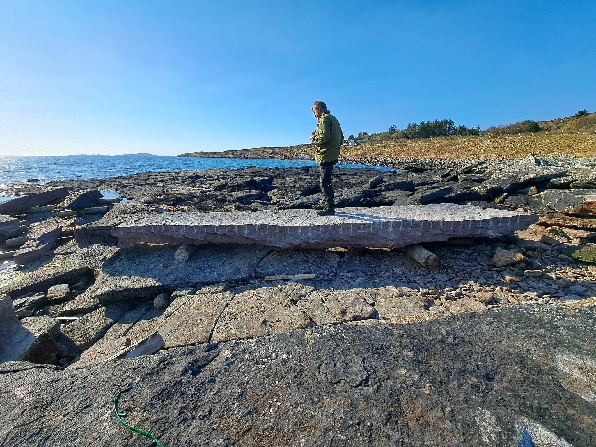 The Lorg na C&ograve;igich project took another step forward on Tuesday when the ground at the monument&rsquo;s site, overlooking the Summer Isles, was broken with the digging of a test pit, in preparation to receive the large standing stone which wi