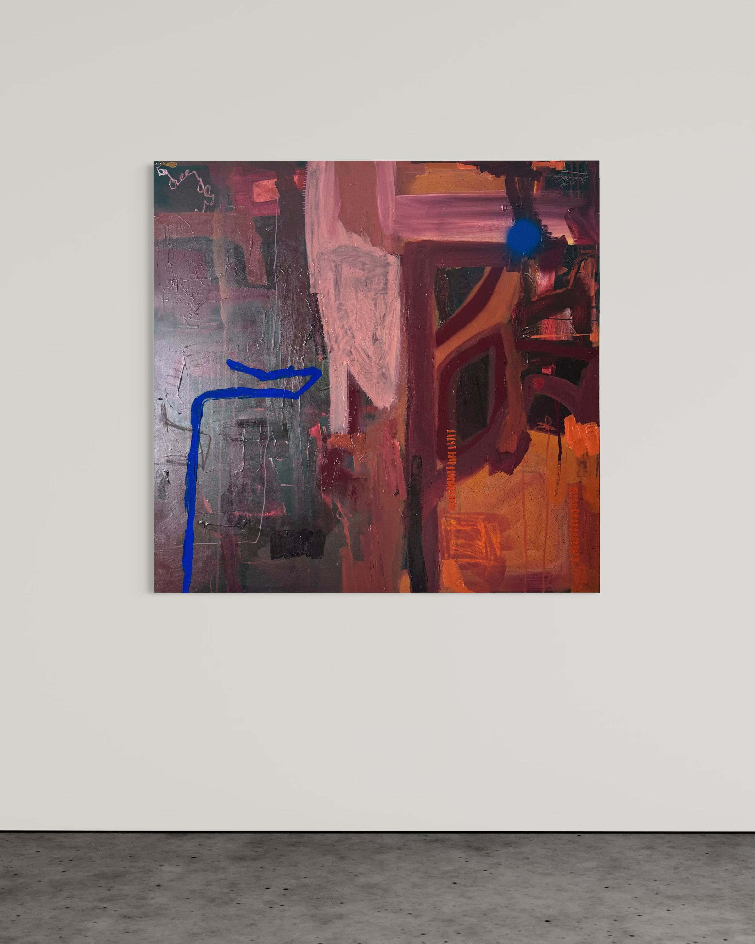 Abstract painting with shades of pink, red, orange, and dark colors, featuring a blue curved line and a dark blue circle, displayed on a white wall in an art gallery.
