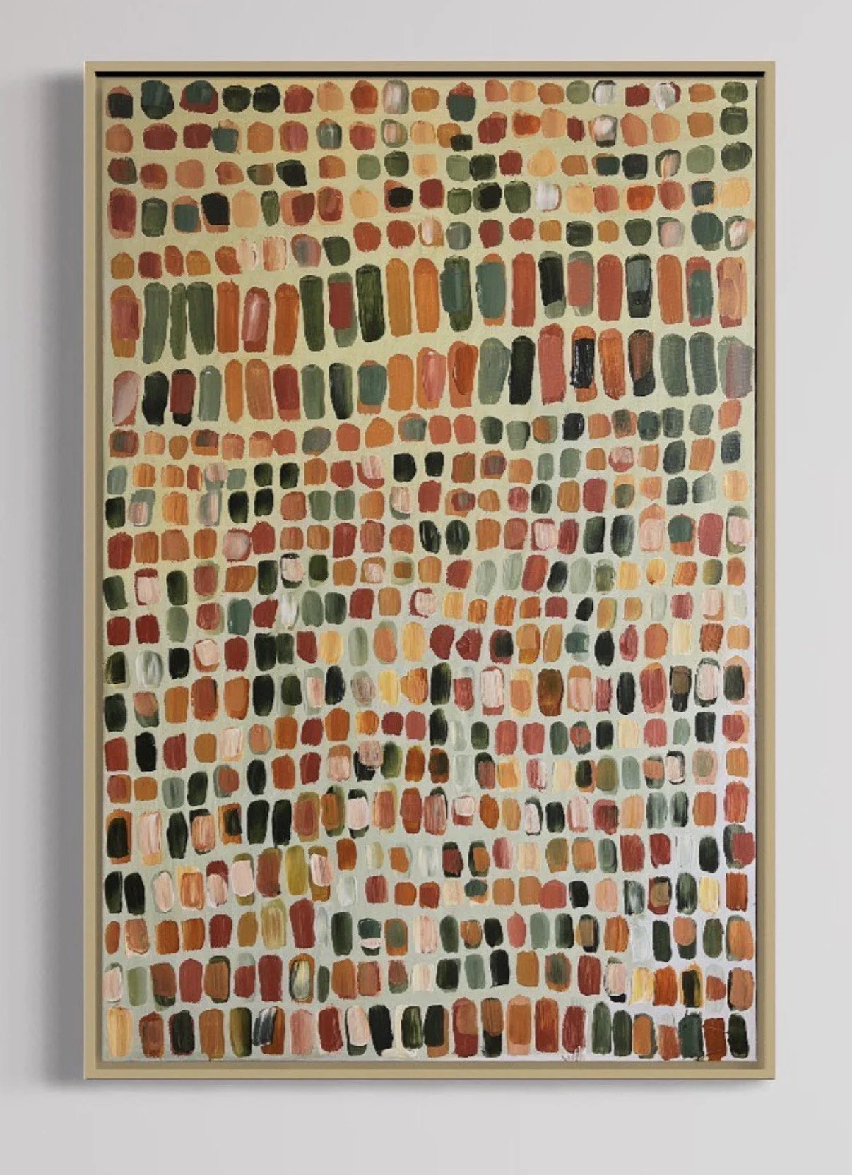 An abstract painting with colorful rectangular and rounded brushstrokes arranged in a grid pattern, framed in light wood.