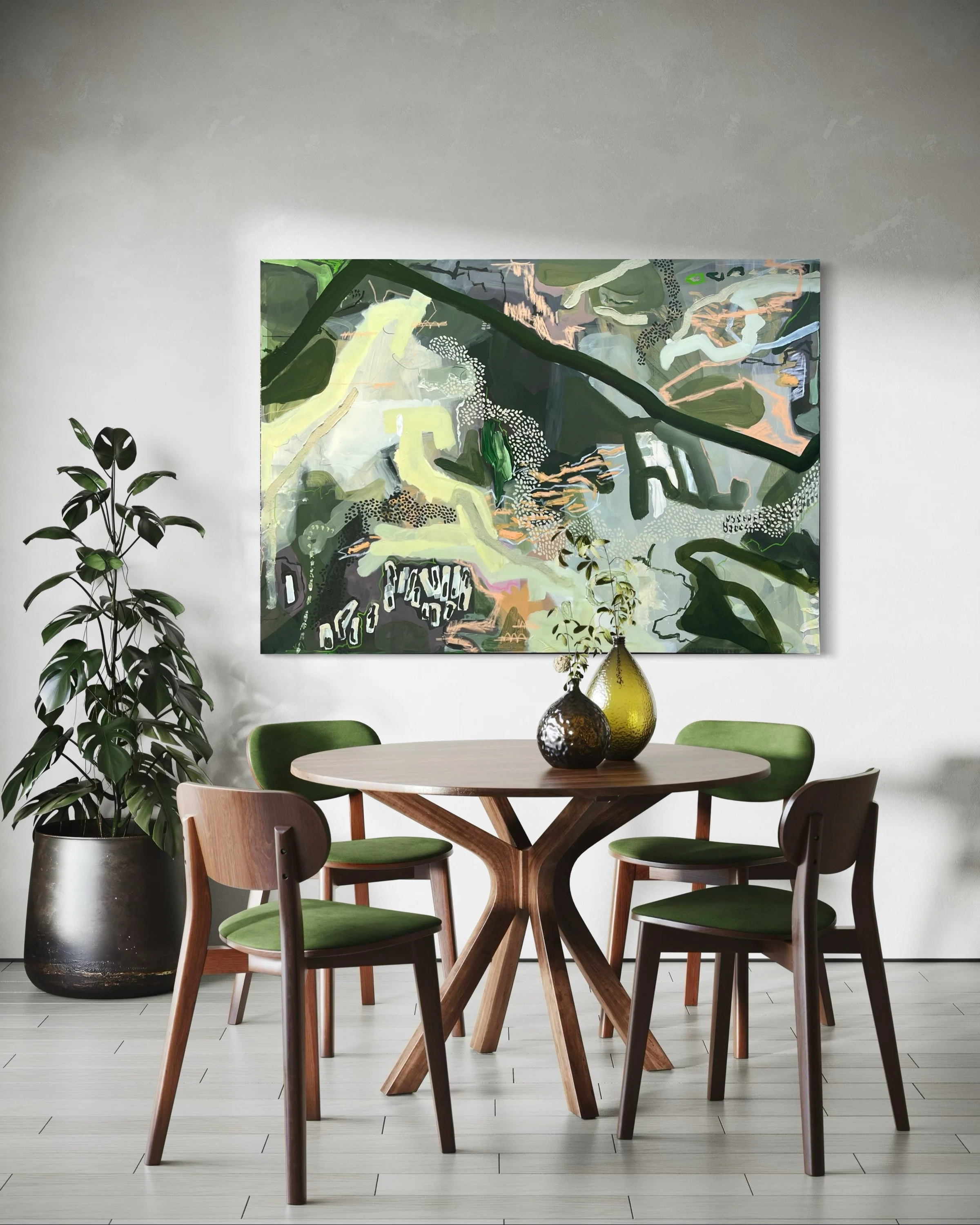A modern dining area with a round wooden table, six green-cushioned chairs, a potted plant, and an abstract painting on the wall behind the table.