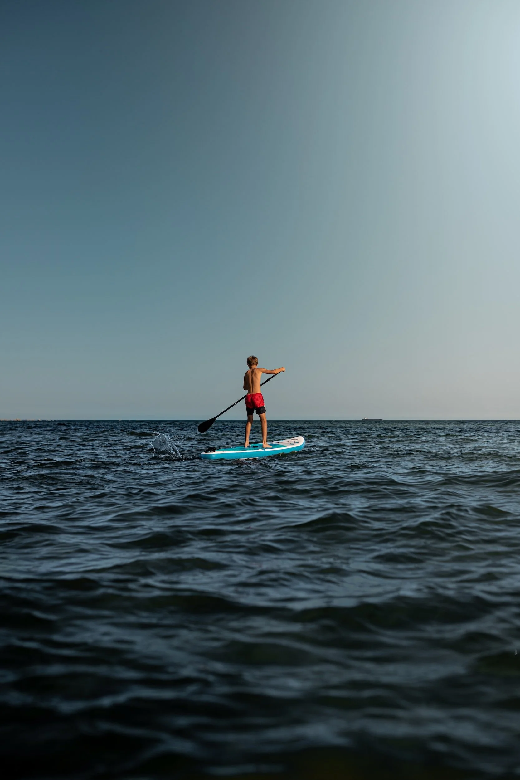 Kid doing canoe at the sea