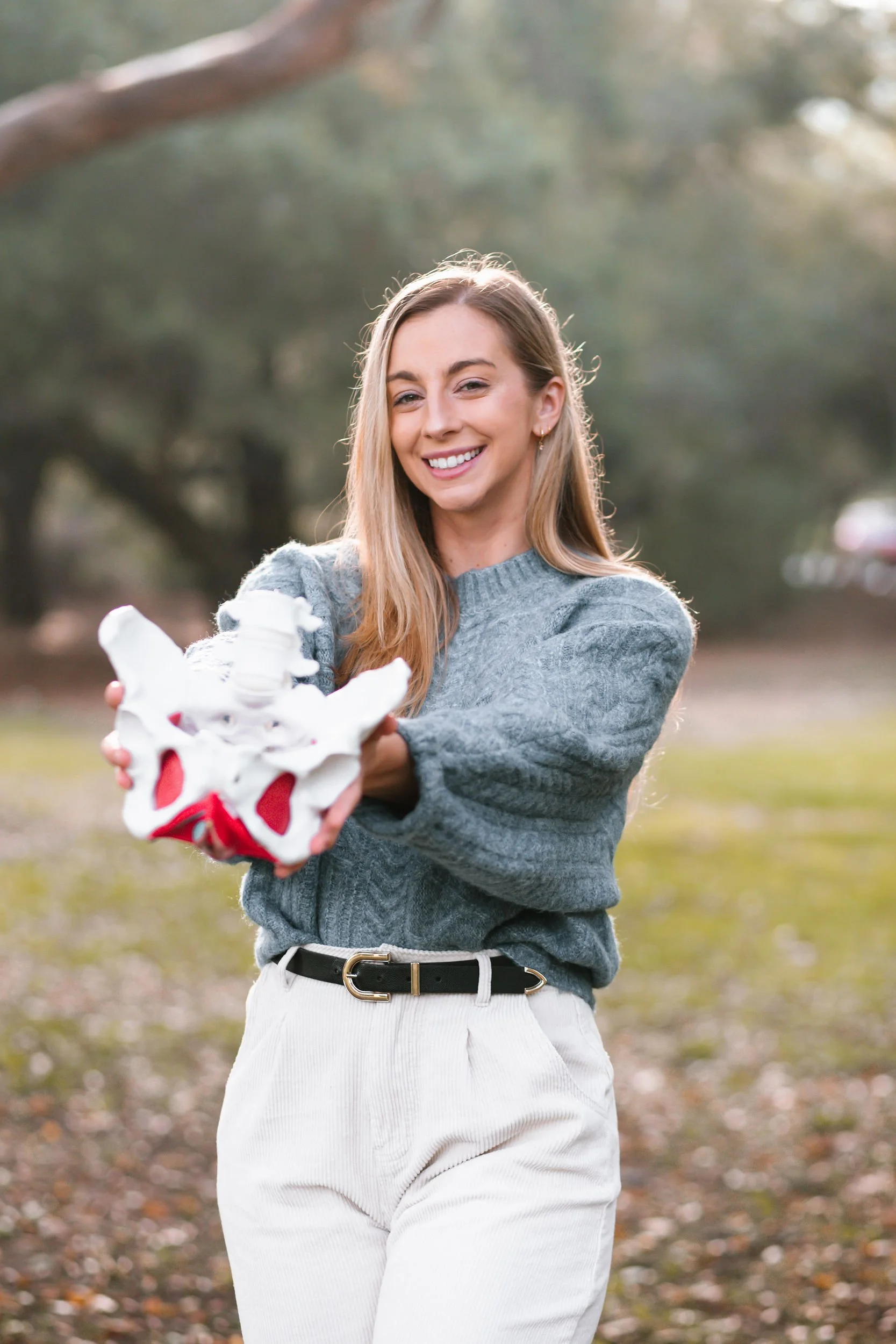 Dr. Allea holds a model of the pelvis