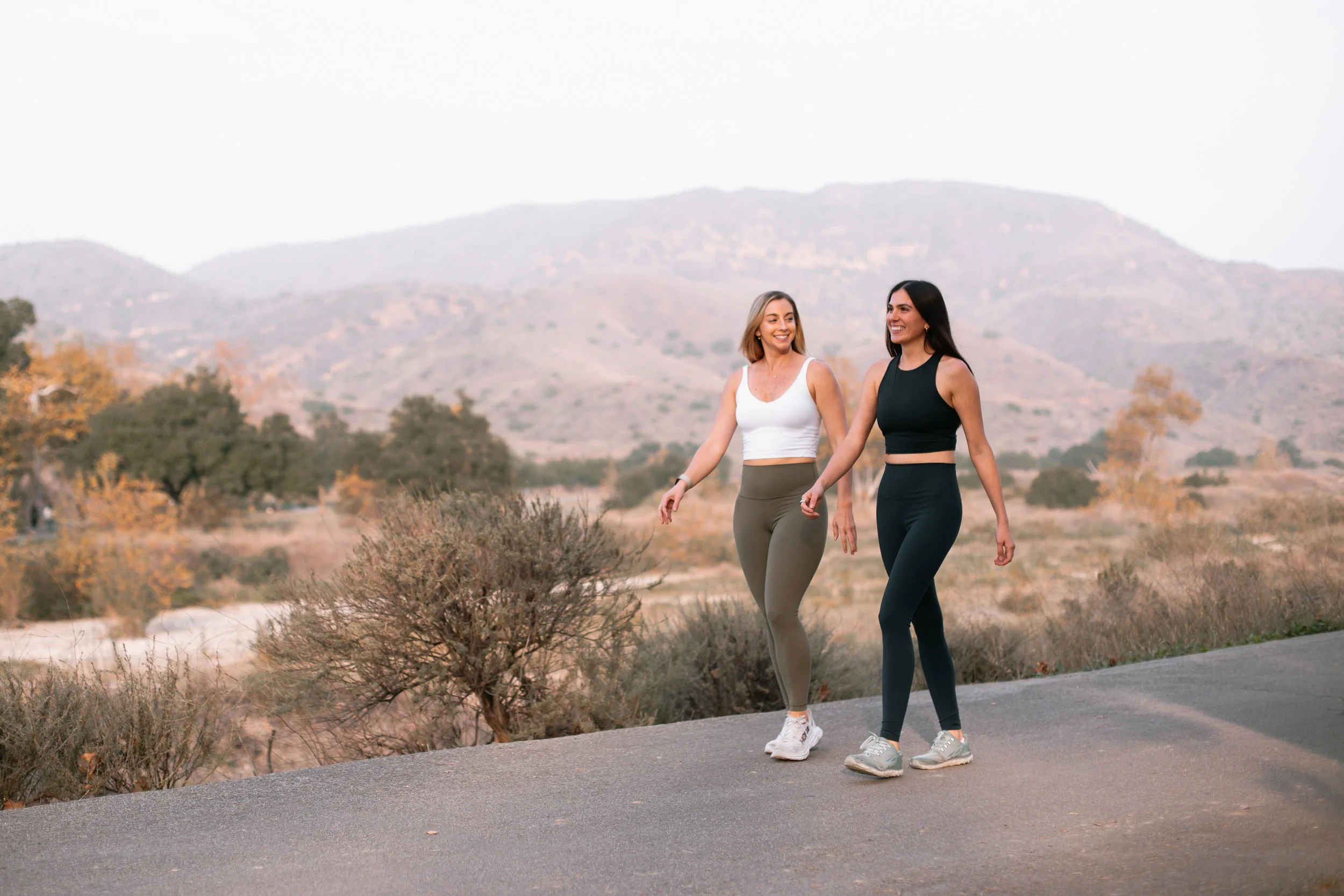 Dr. Mallorie and Dr. Allea Walk along an outdoor trail