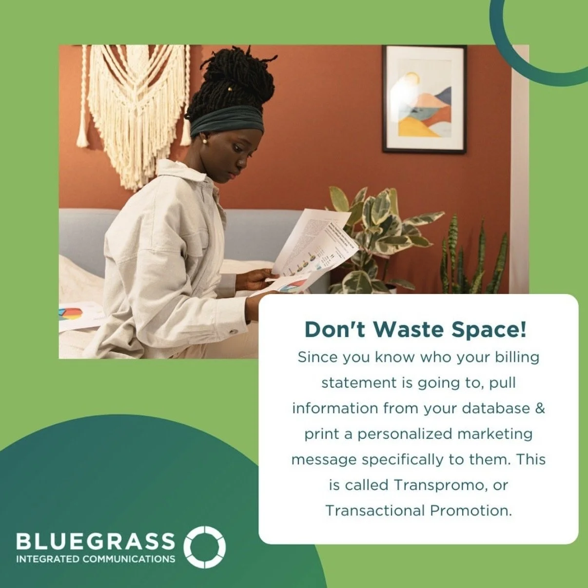 Young woman sitting on her bed reading her bills