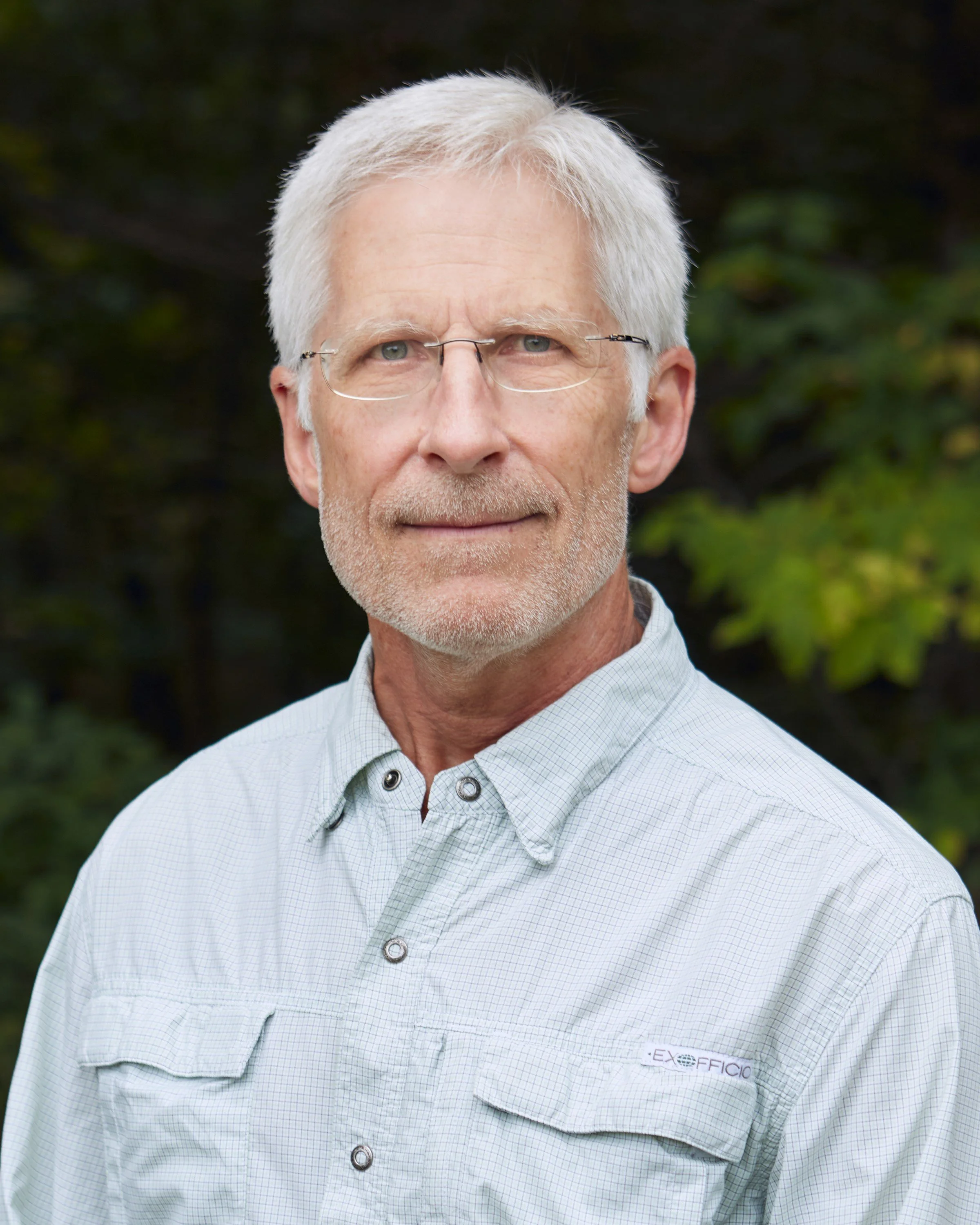 man looking at camera outdoors