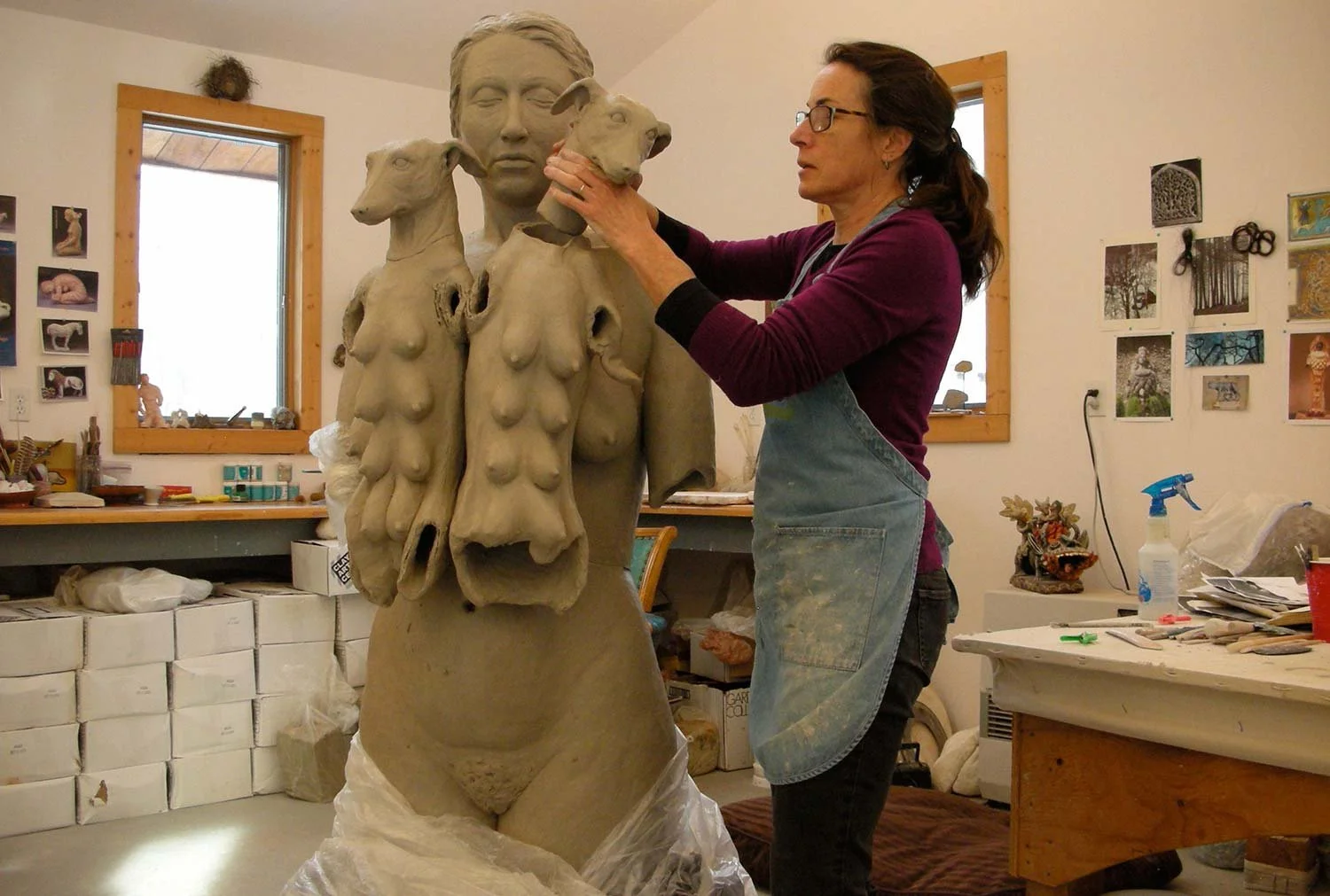 a woman working on a sculpture