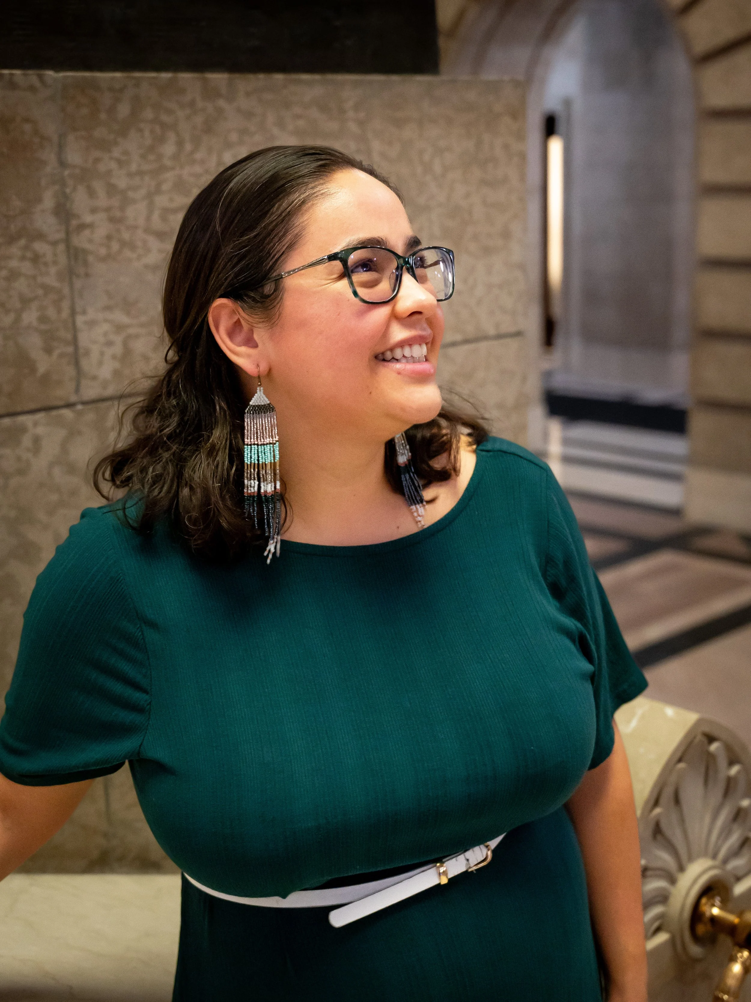 A woman smiling with glasses