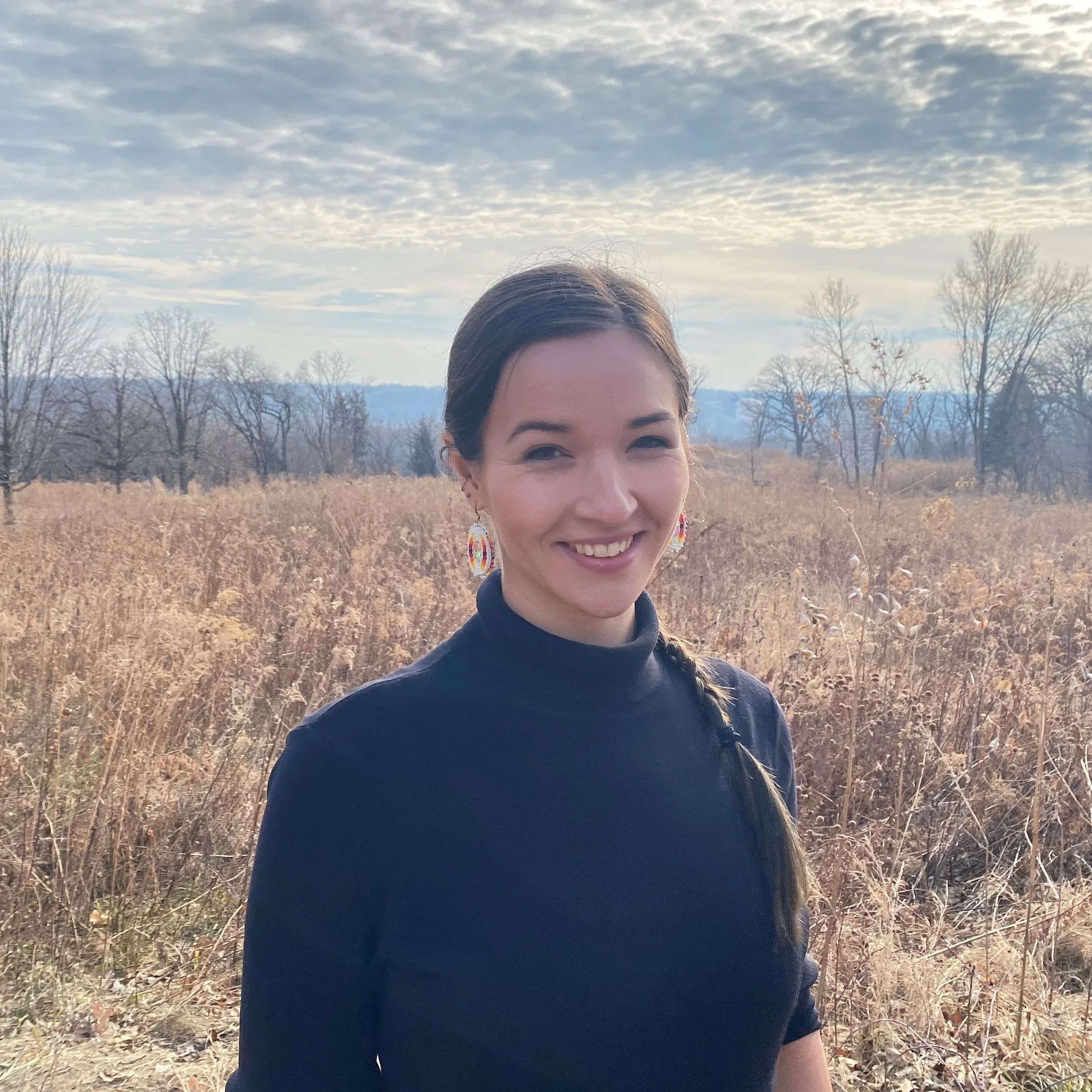 A woman outside smiling