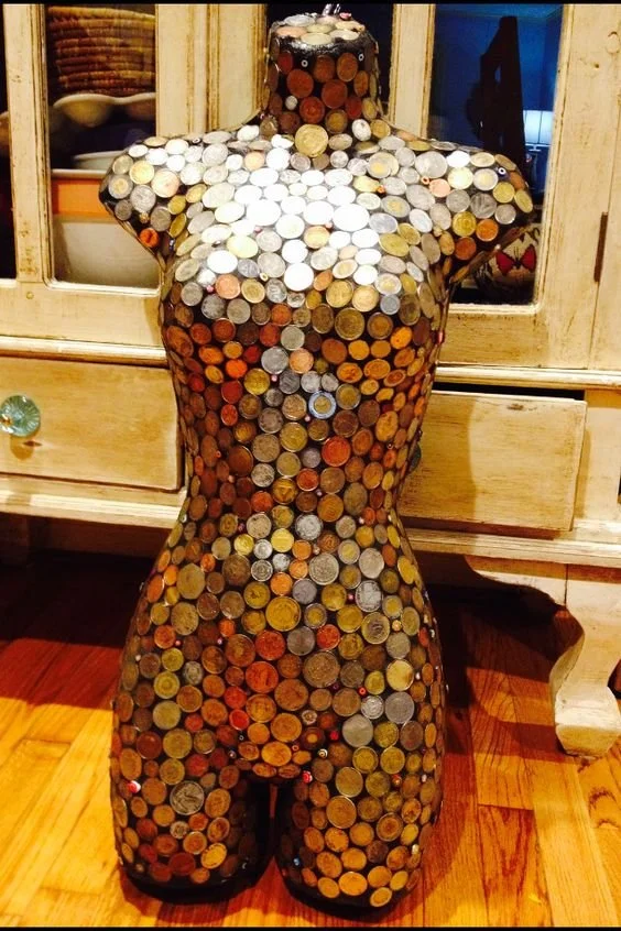 foreign coins on mannequin
