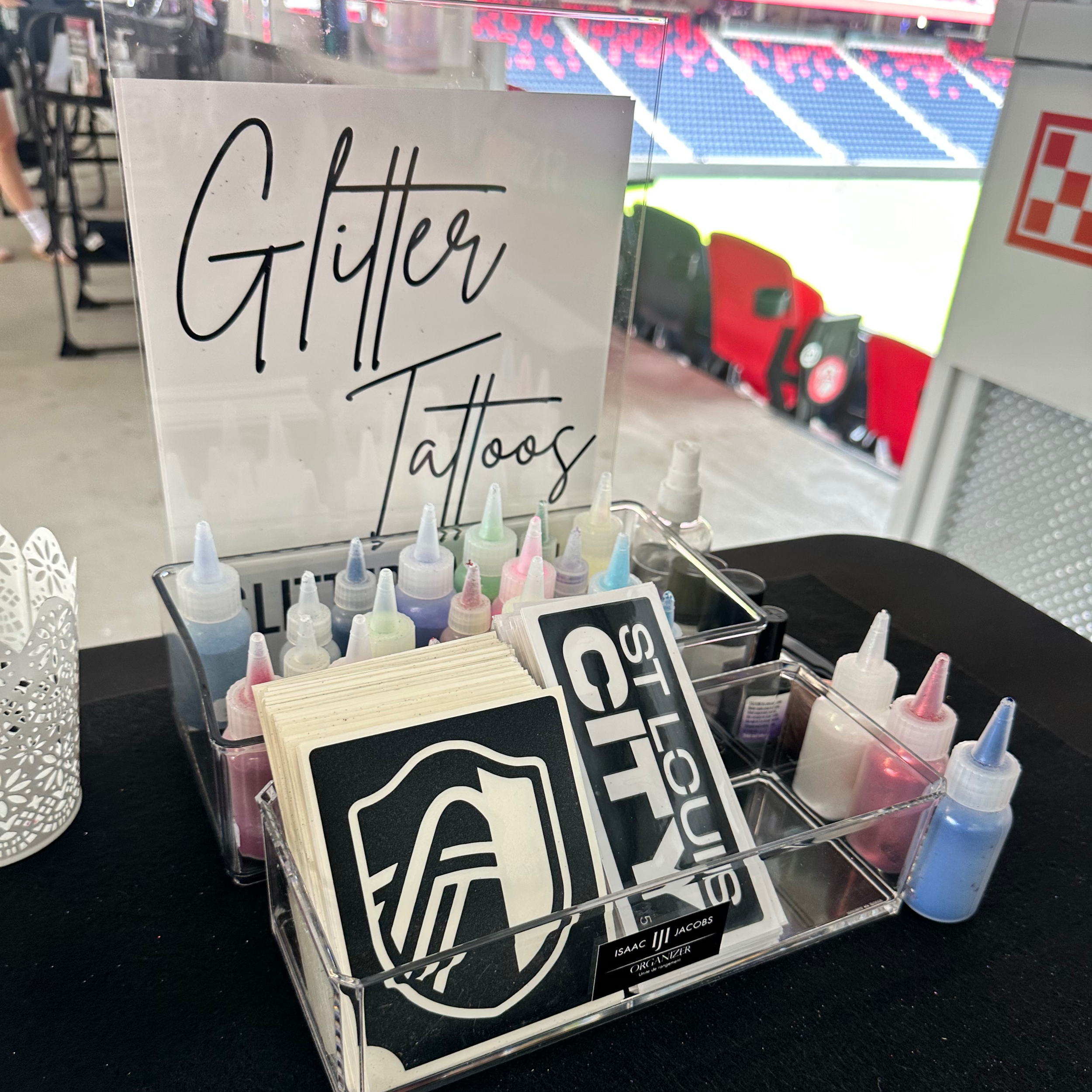 “St. Louis CITY glitter tattoo stencils displayed at a professional sports event activation.”
