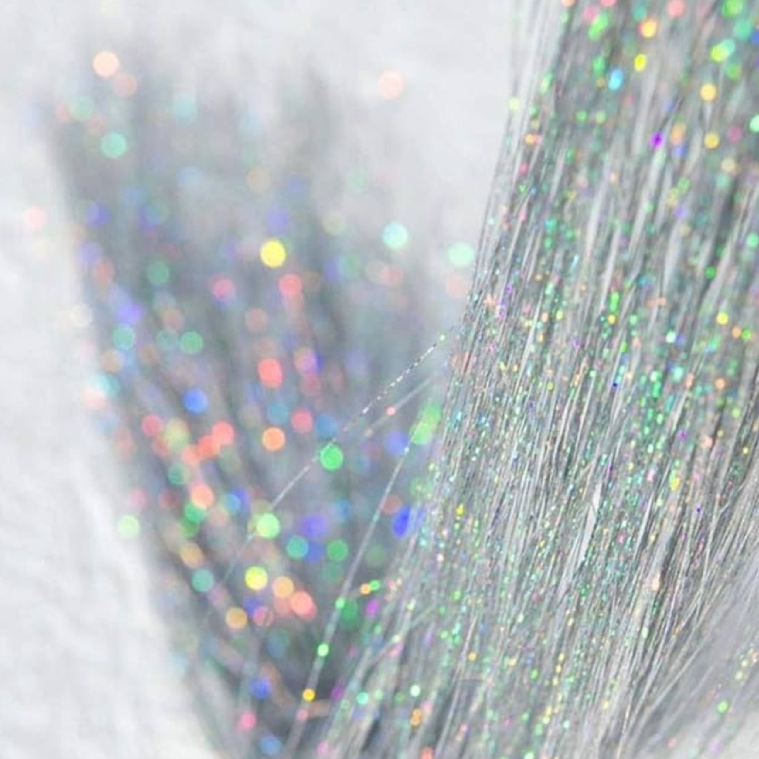 Holographic silver hair tinsel used for event and festival styling.