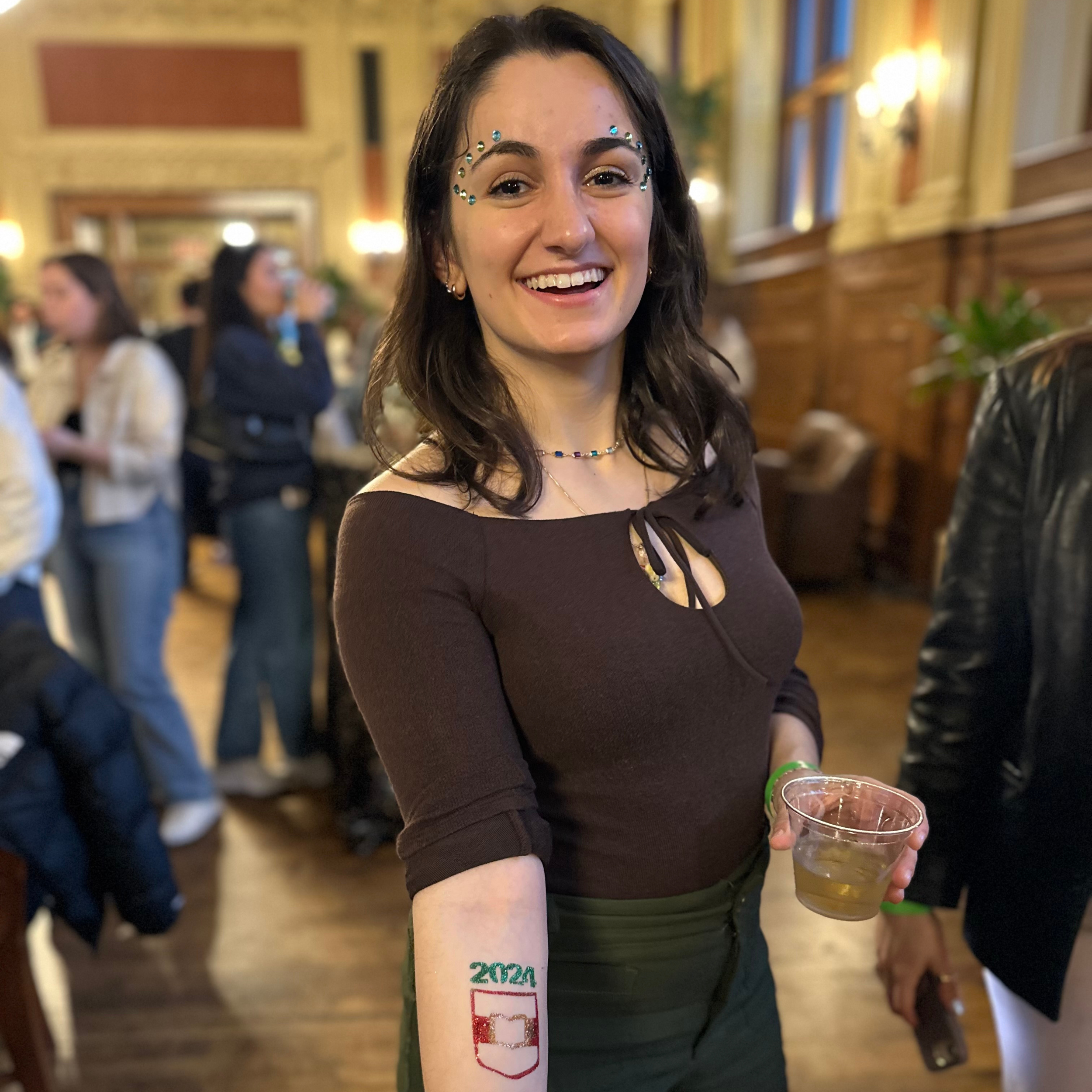 Washington University student celebrating the anniversary of their graduation with glitterbar stl. Glitterbar stl provided a corporate brand experience with glitter and gems as well as custom glitter tattoos
