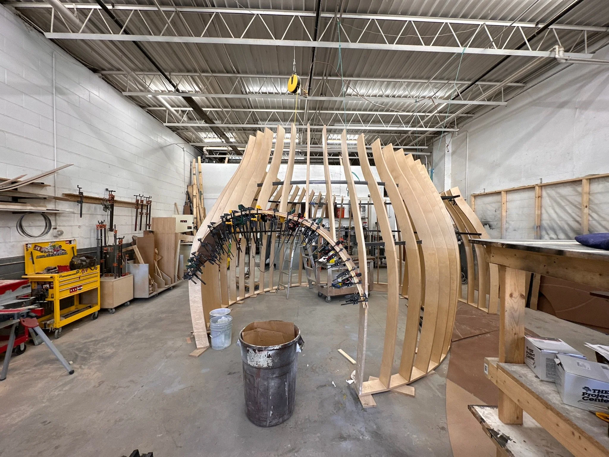 Woodworking shop with clamped wooden arches and tools