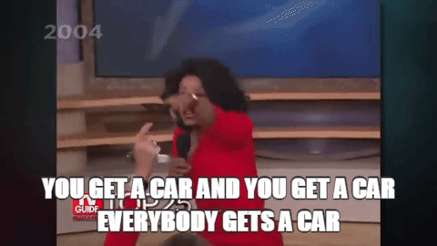 Oprah pointng around at audience say "you get a car, everybody gets a car"