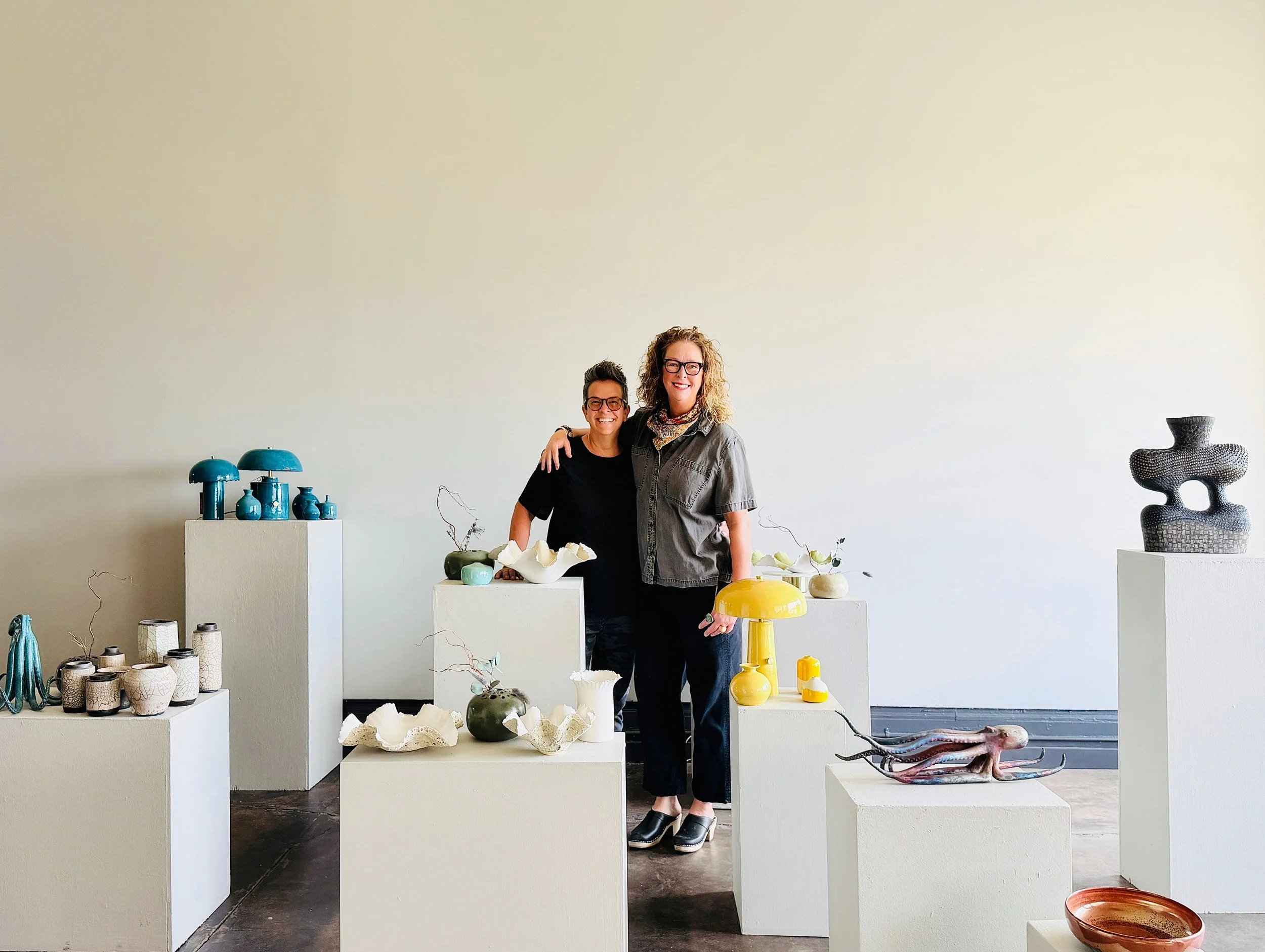 Bibi Bielat Cathy Caracciolo in a gallery with their pottery, lamps, bowls and sculptures, ikegami