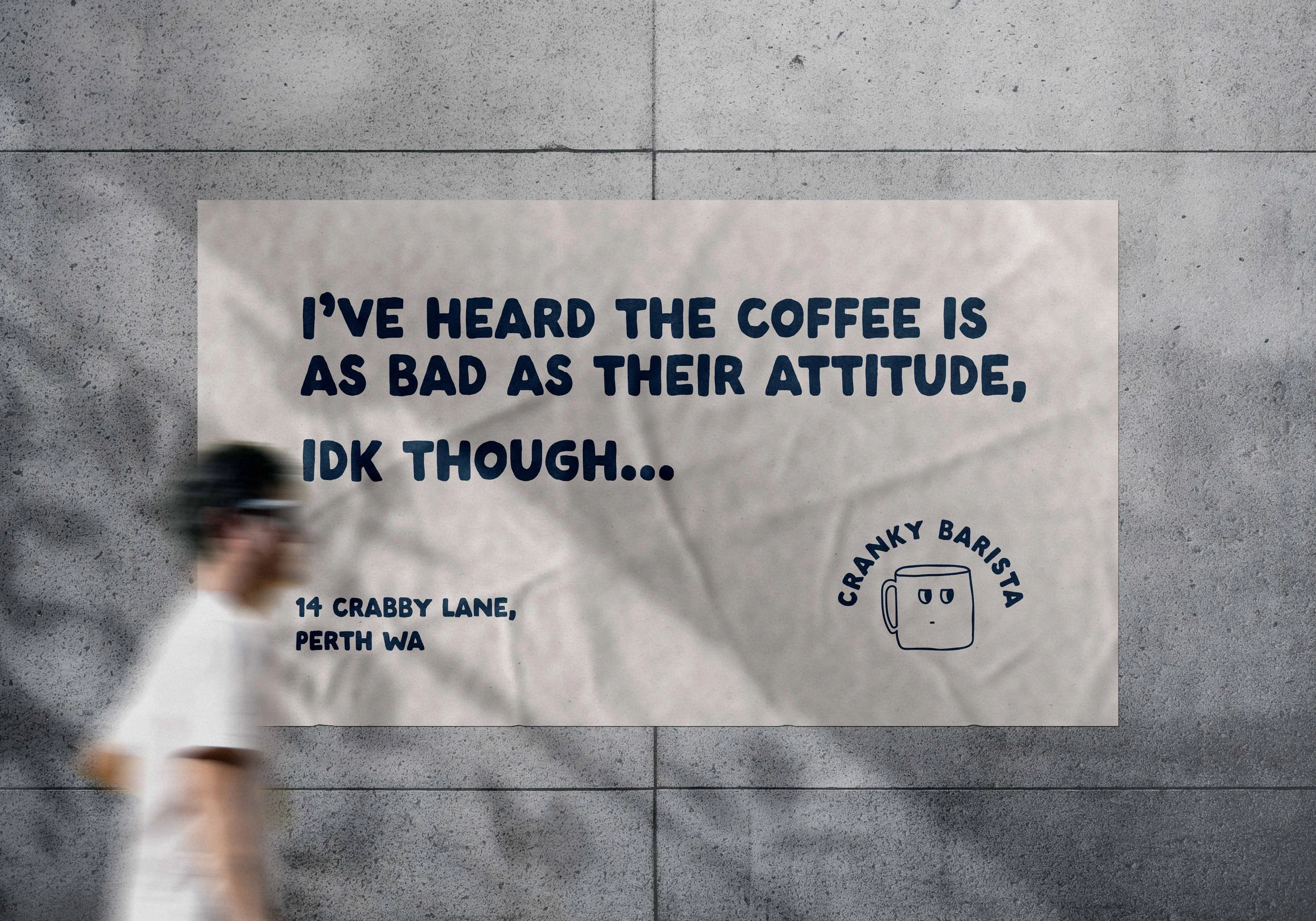 A blurred person walking past a large poster on a gray concrete wall. The poster features a quote, the address '14 Crabby Lane, Perth WA,' and a simple illustration of a coffee mug with a face, labeled 'Cranky Barista.'
