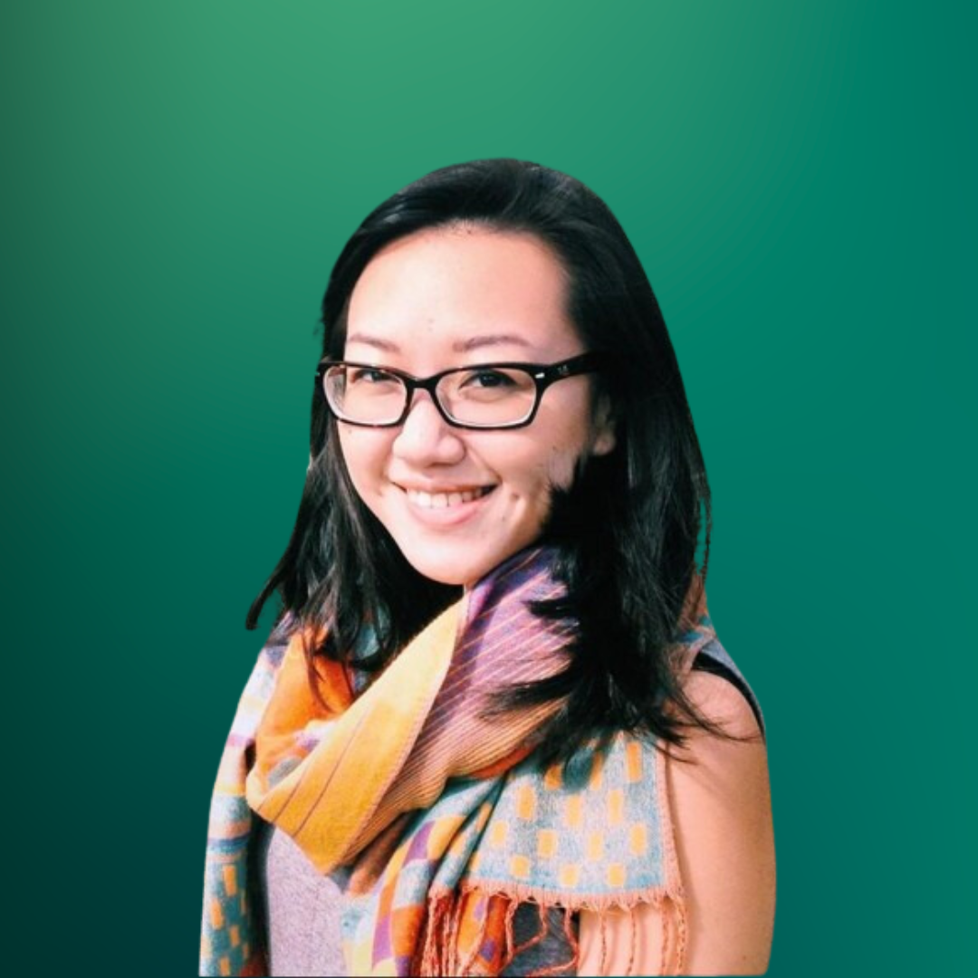 Portrait of a young woman with black hair, glasses, smiling, wearing a multicolored scarf, against a green gradient background.