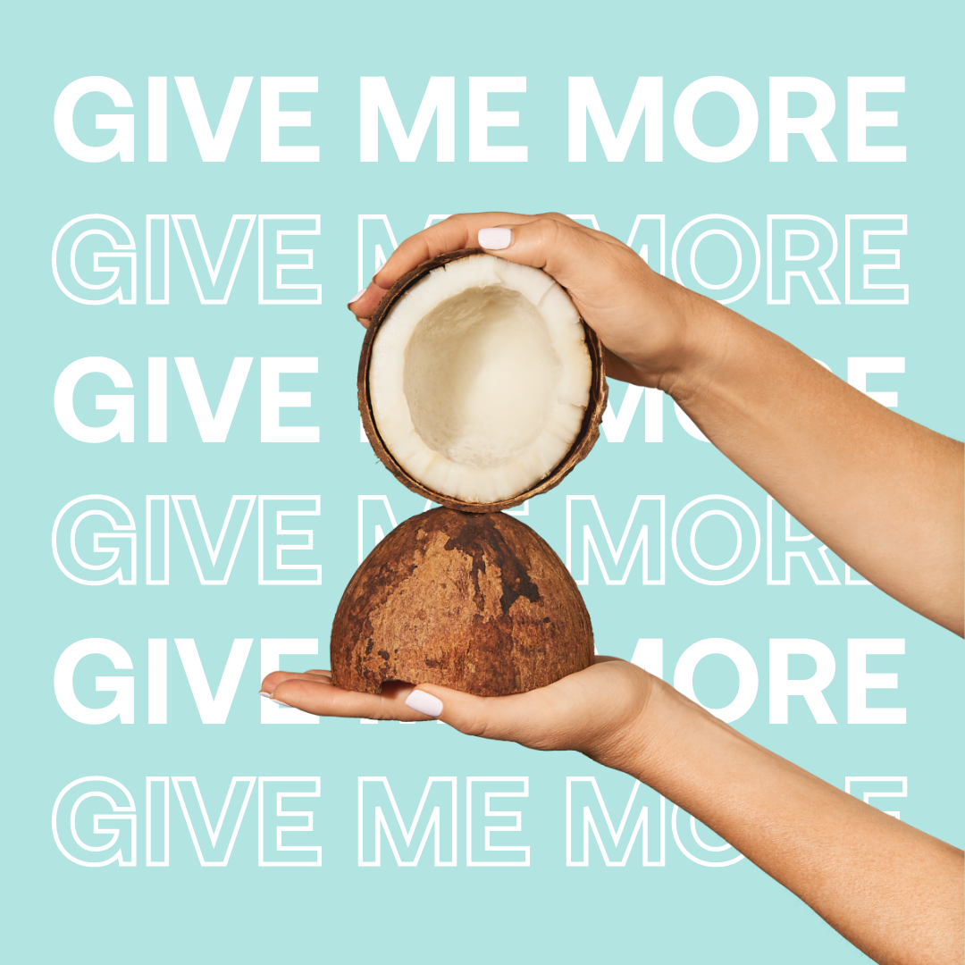 Hands holding a cracked open coconut against a background with the text 'GIVE ME MORE' in white and outline on a blue backdrop.