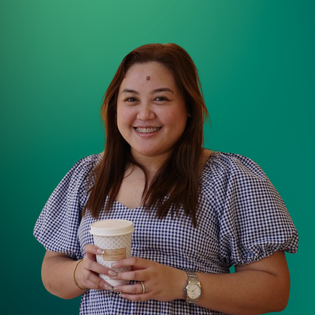 A woman with long brown hair, wearing a checkered blouse, holding a coffee cup with a white lid, smiling against a green gradient background.
