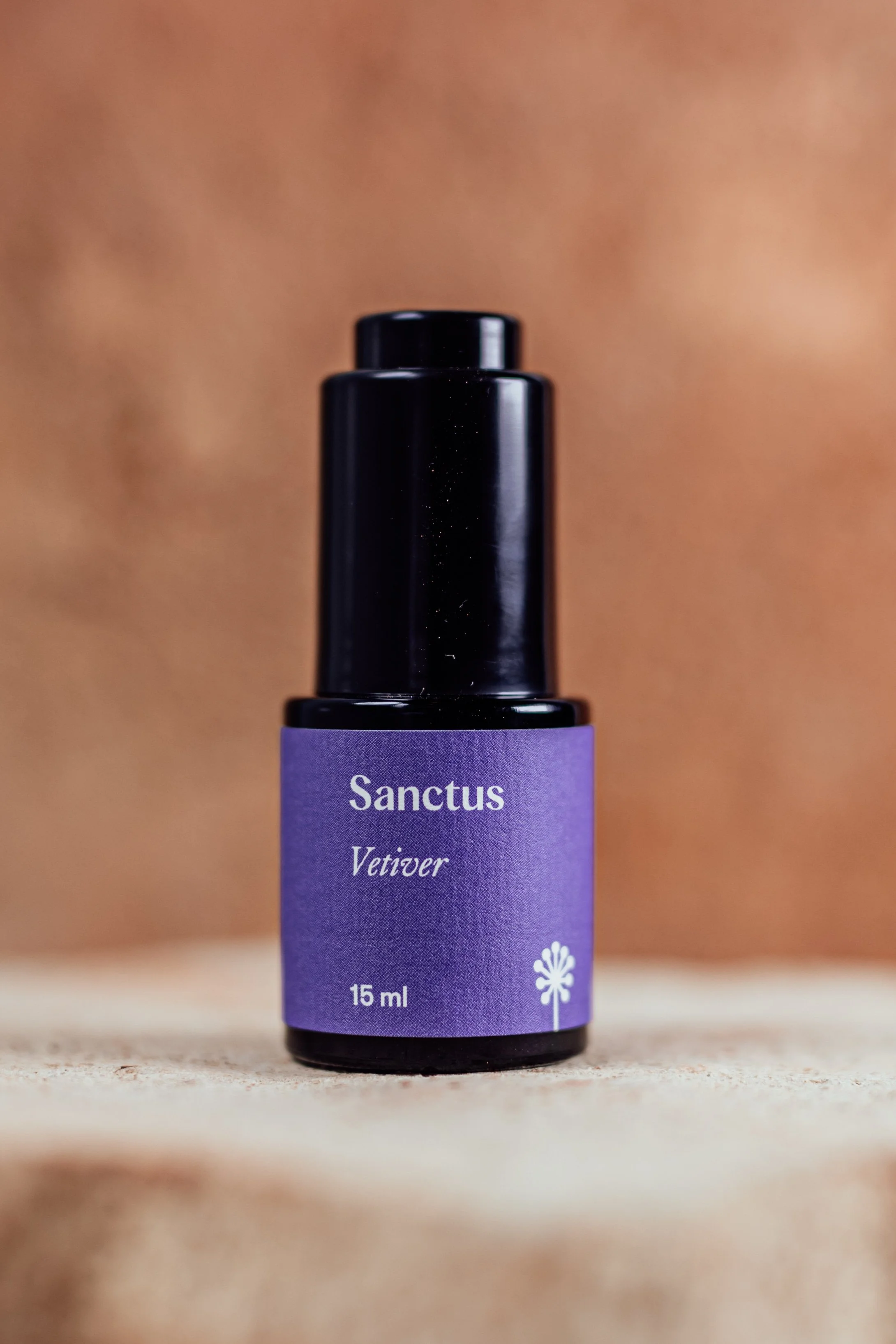 15 mL violet Miron bottle of Sanctus Vetiver oil — Vetiveria zizanioides (Khus) in jojoba, wild-harvested and hydro-distilled in India.