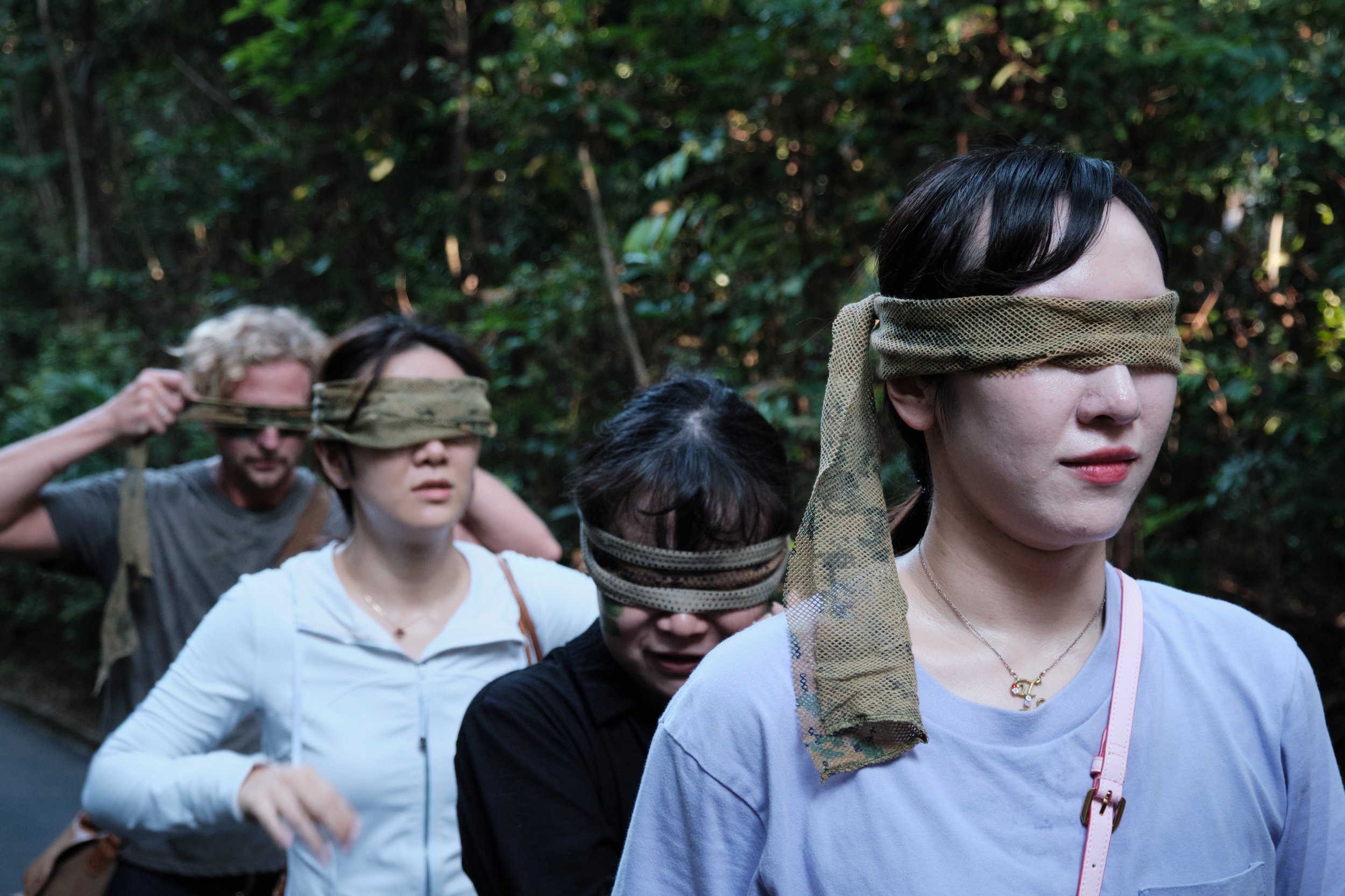 NORDEN team member wearing a blindfold during a trust walk at Fort Serapong, a corporate team bonding activity in Singapore