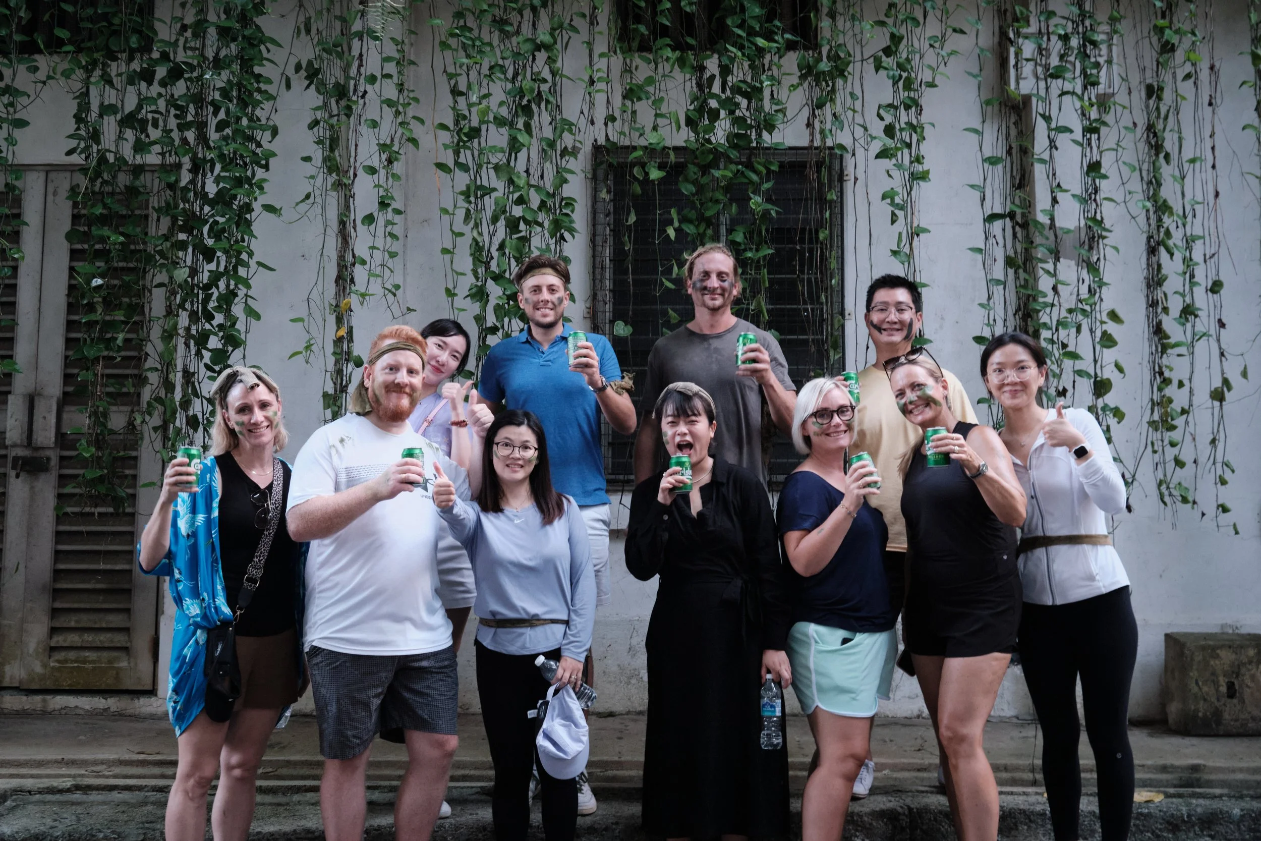Global corporate team celebrating together after completing challenges at Fort Serapong, Singapore