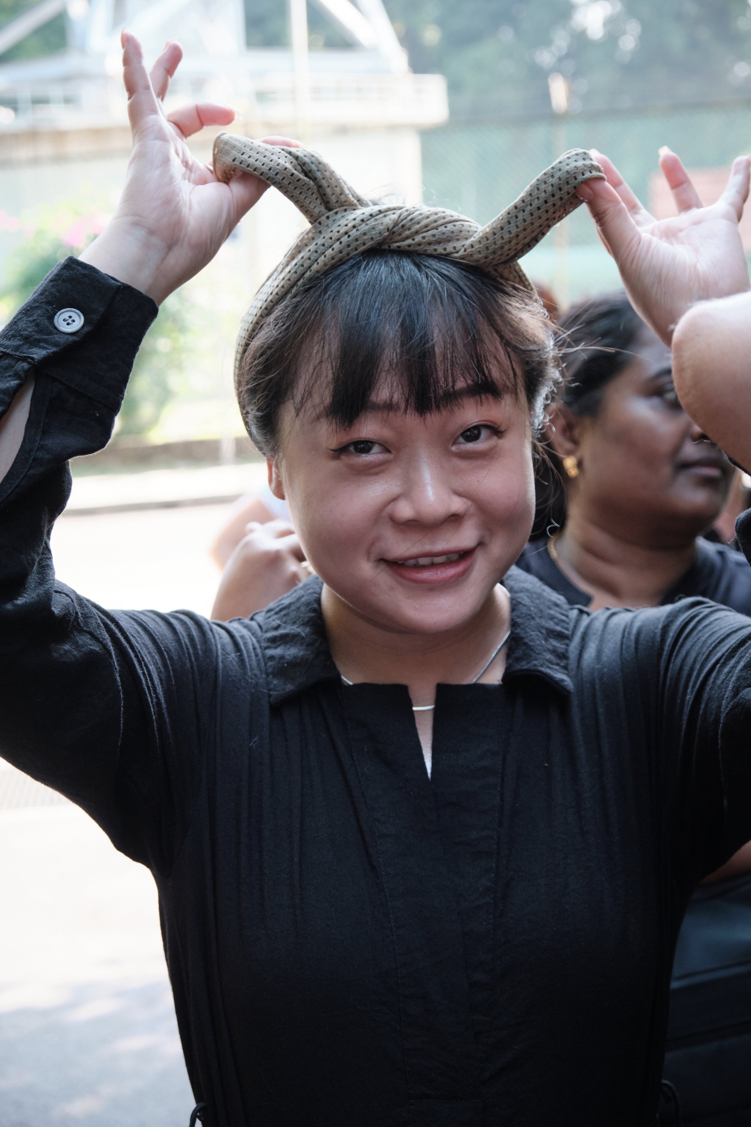 Team member celebrating with raised arms during the Fort Serapong corporate team bonding day in Singapore