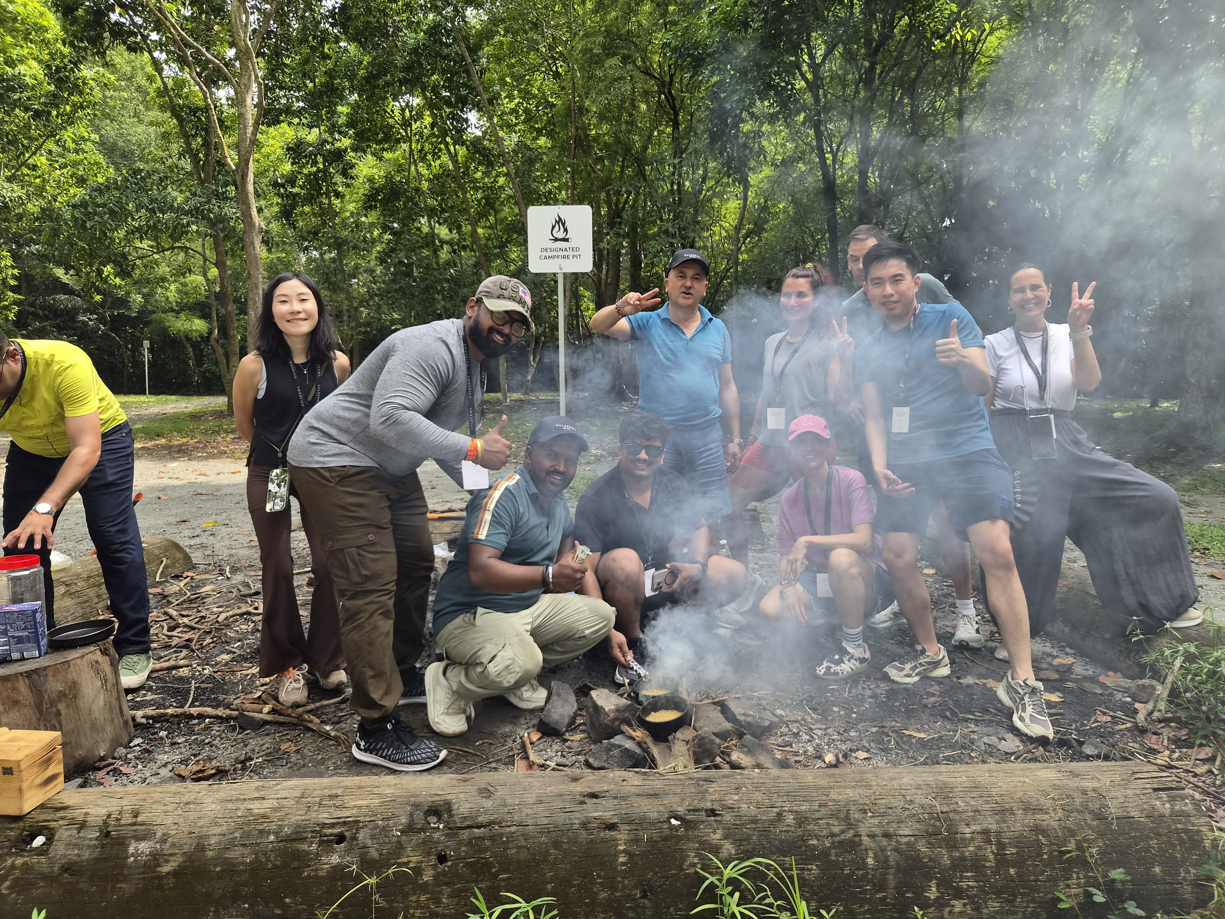 Colleagues working together on a fire-craft challenge during a corporate offsite