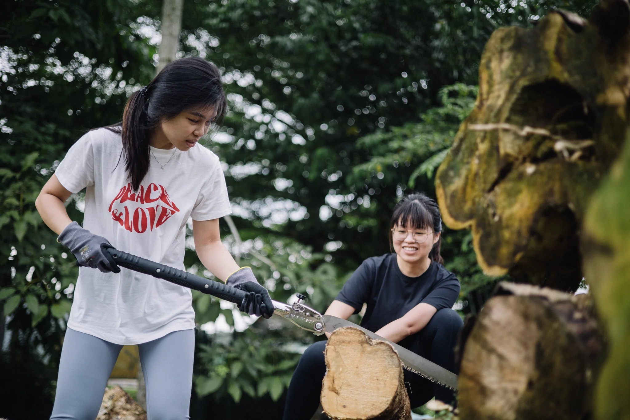 She grabbed the saw first. The quiet one steadying the log is the reason it went anywhere near straight.