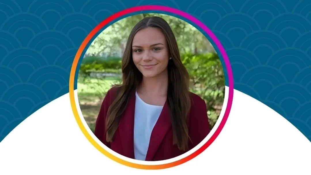 Portrait of a young woman with long brown hair smiling outdoors with greenery in the background, surrounded by a colorful circular border.
