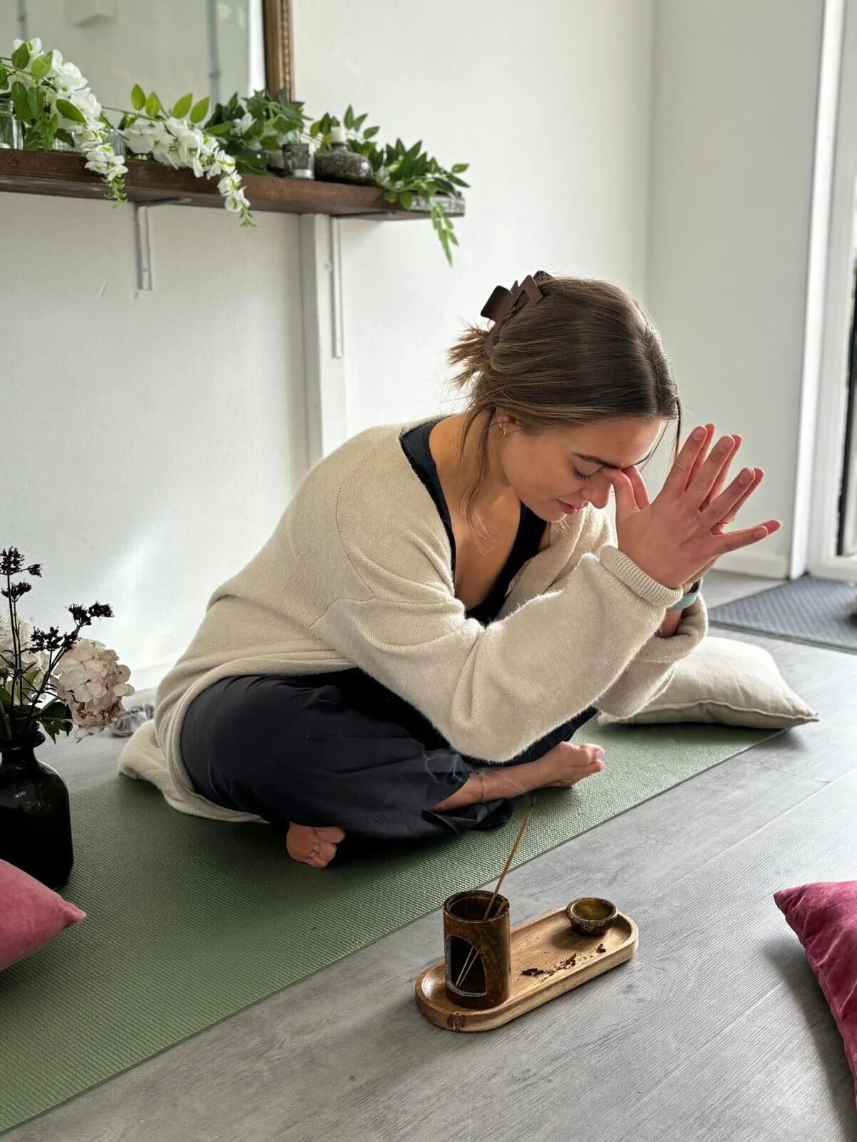 Yoga teacher doing a beginners pose for their class