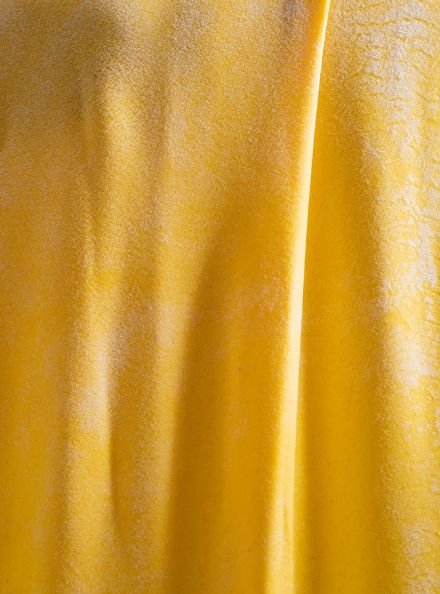  Fresh pasta being rolled and dusted with flower 