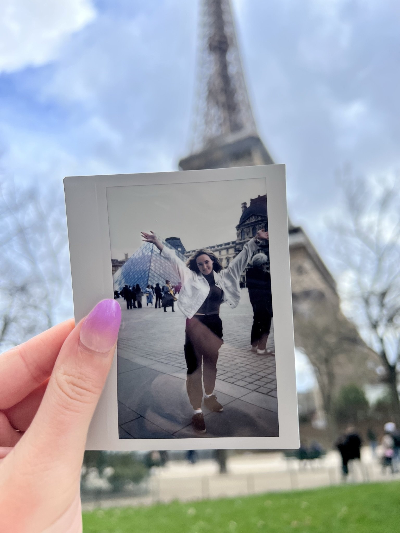 Polaroid in foreground in front of Eiffel Tower