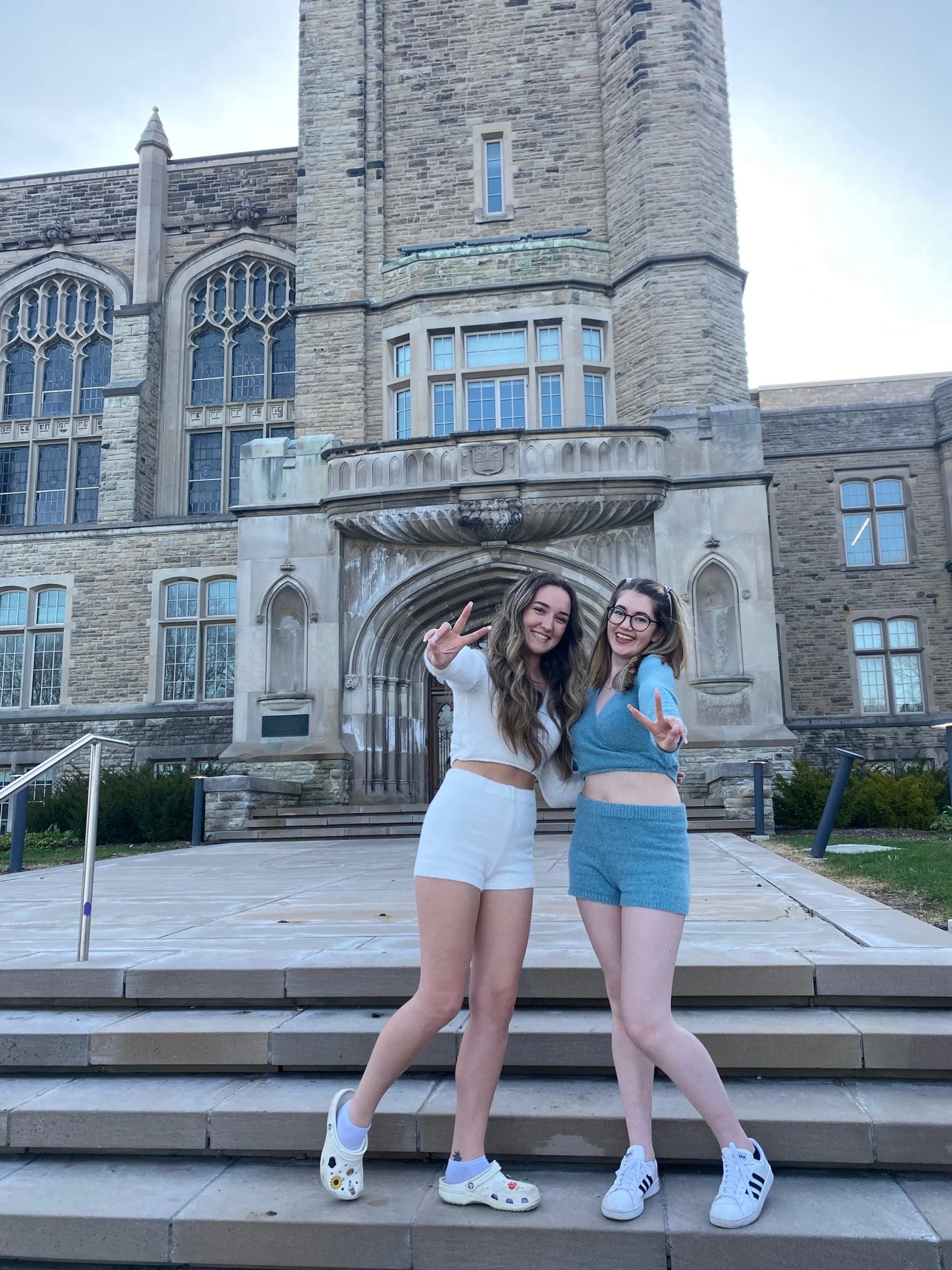two girls throwing peace signs
