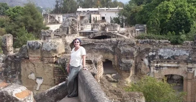 woman in front of building in Antigua