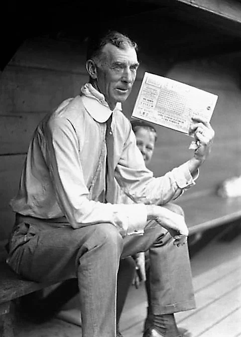 MACK CONNIE in dugout w scorecard.jpg