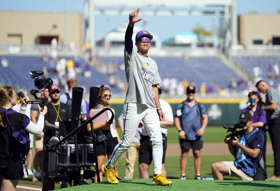 Derek Curiel at the College World Series, pointing to the sky with his right hand, Omaha, Nebraska - https://710keel.com/ncaa-bans-curiel-song/